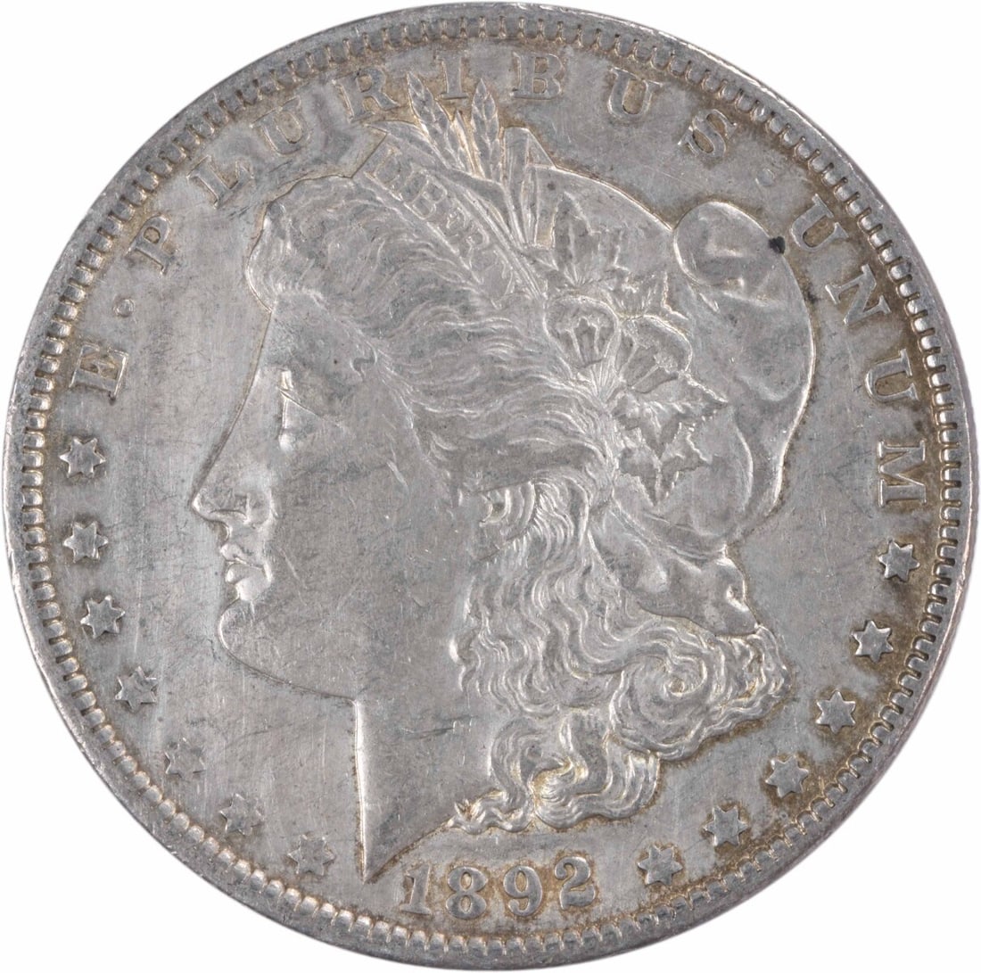 Uncertified Au Dollar Silver Morgan 1892: Uncertified Au Dollar Silver Morgan 1892 The 1892 Au Dollar Silver Morgan features a striking design with George T. Morgan's iconic portrait on its obverse, surrounded by intricate details and