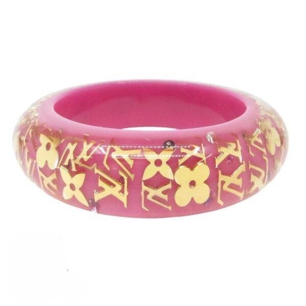 Brasle Pink Inclusion Original Box with LV GM M6501: Brasle Pink Inclusion Original Box with LV GM M6501 The Louis Vuitton GM M6501 bracelet features a striking pink resin bangle with an original box. This unique piece showcases the iconic LV design in