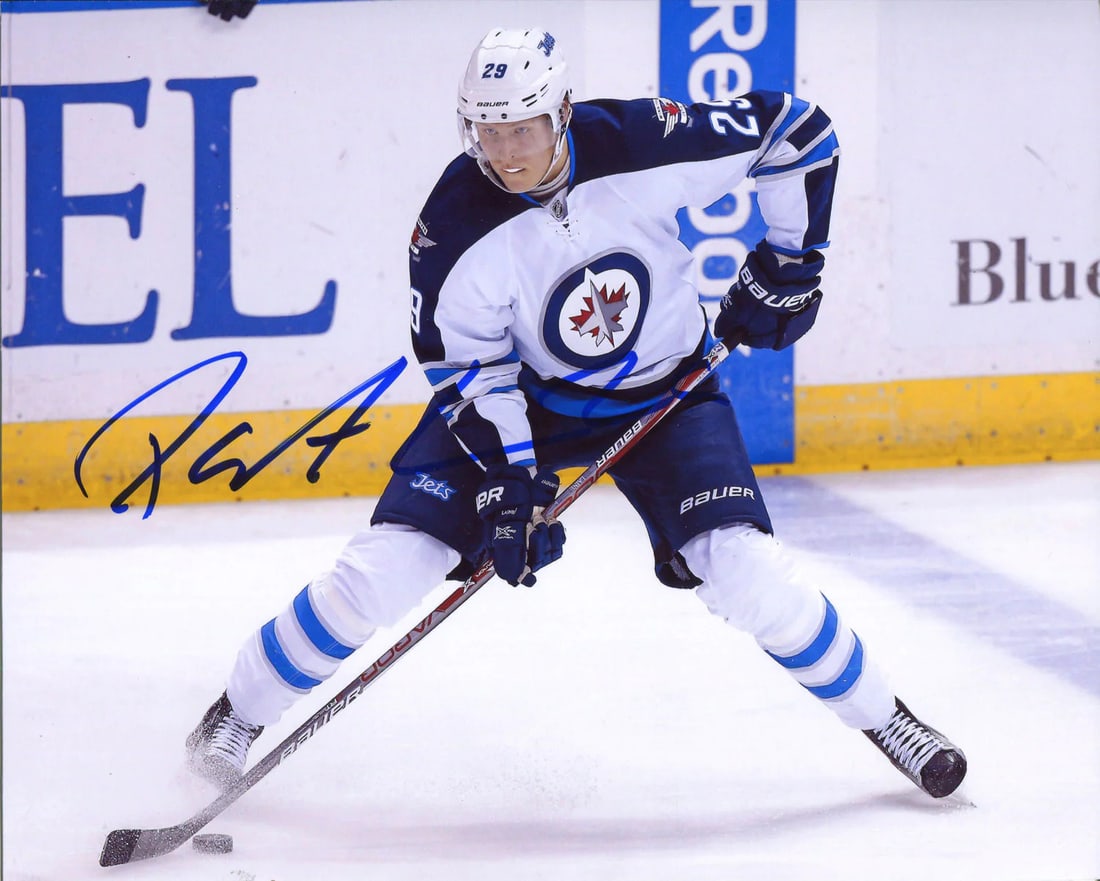 Laine Patrik Autographed Photo 8x10: Laine Patrik Autographed Photo 8x10 Authentic 8x10 photo of Patrik Laine signed in blue sharpie across the image. The photo captures Laine in action with the Winnipeg Jets, showcasing his skills on