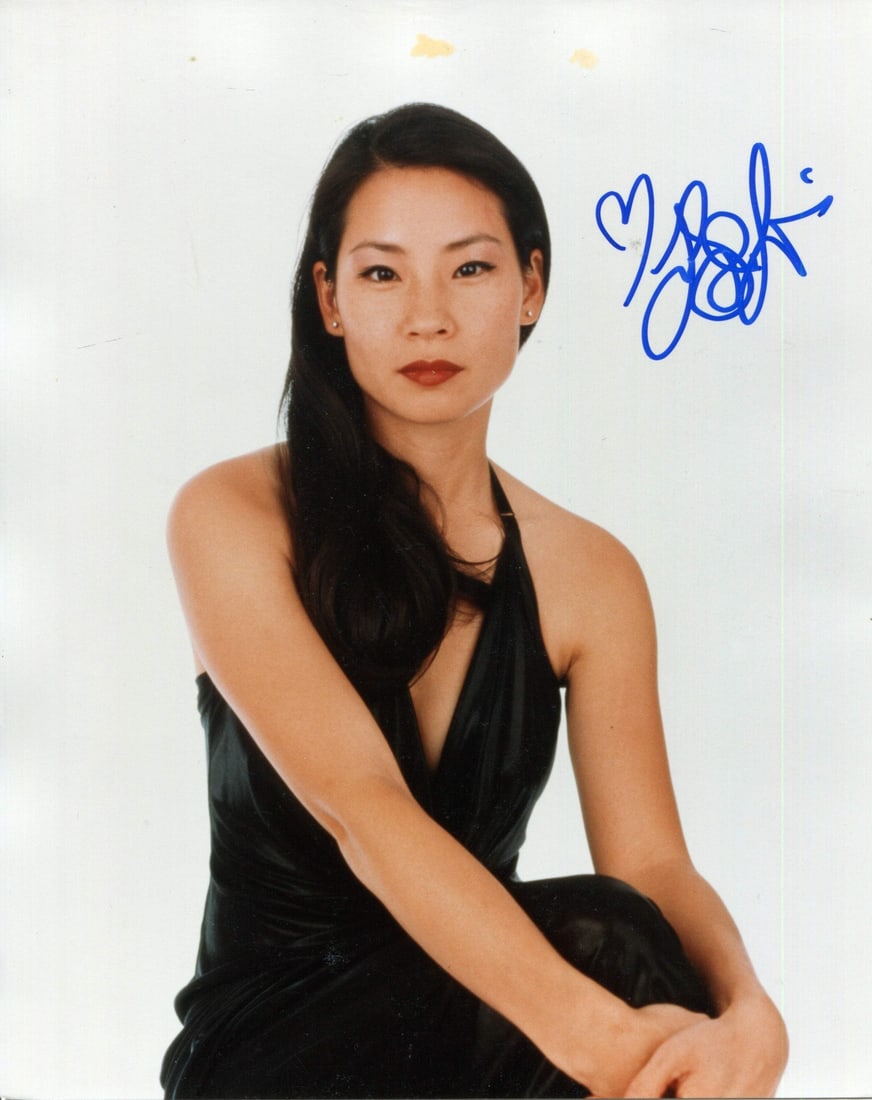 Liu Lucy Autographed Photo 8x10: Liu Lucy Autographed Photo 8x10 Lucy Liu's striking presence shines in this 8x10 photo, signed across the front in blue sharpie. The image captures her unique energy and charisma, making for a compell