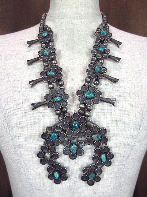 Vintage Navajo Squash Blossom Necklace/ Turquoise Sterling Silver: Vintage Navajo Squash Blossom Necklace/ Turquoise Sterling Silver Turquoise pendant in sterling silver, characteristic of Navajo design, showcases the natural beauty of blue stone. The necklace