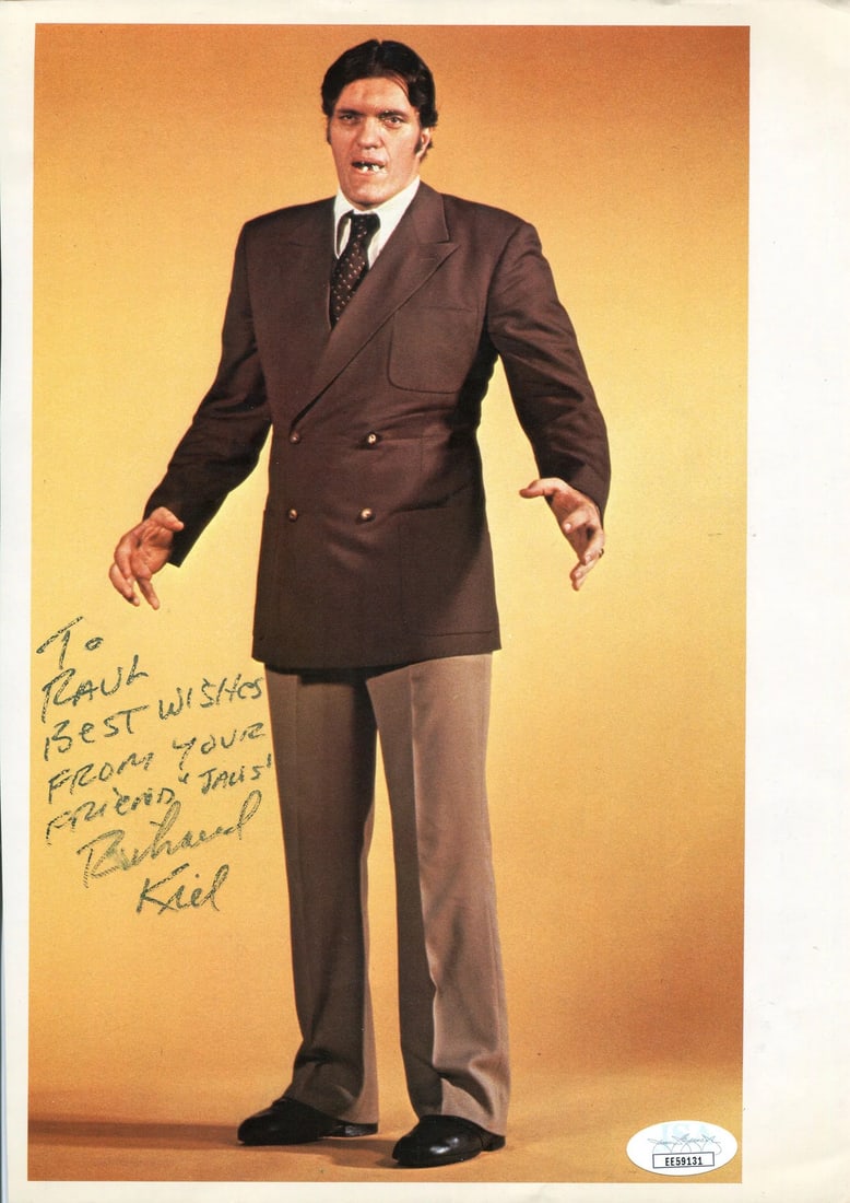 Richard Kiel Autographed 8x10 Photo (JSA): Richard Kiel Autographed 8x10 Photo (JSA) Signed by Richard Kiel in black sharpie, this 8x10 photo showcases the iconic actor's likeness. Provided with authentication from James Spence Authentication 