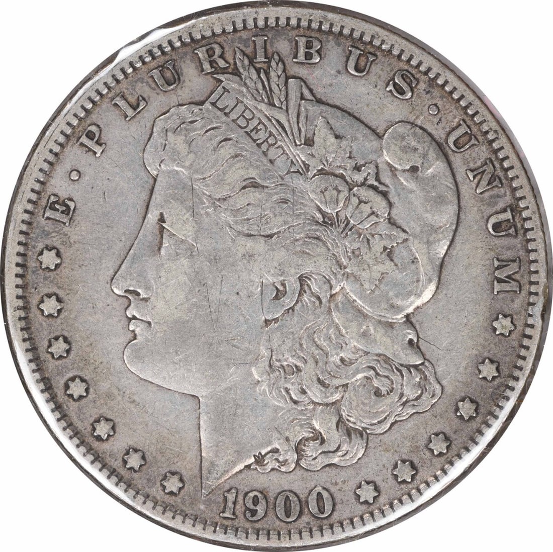 CC Morgan dollar VF Uncertified 1900-O: CC Morgan dollar VF Uncertified 1900-O The CC Morgan dollar, minted in 1900 at the New Orleans Mint, boasts a distinctive reeded edge and a silver-copper composition. This circulated coin features a