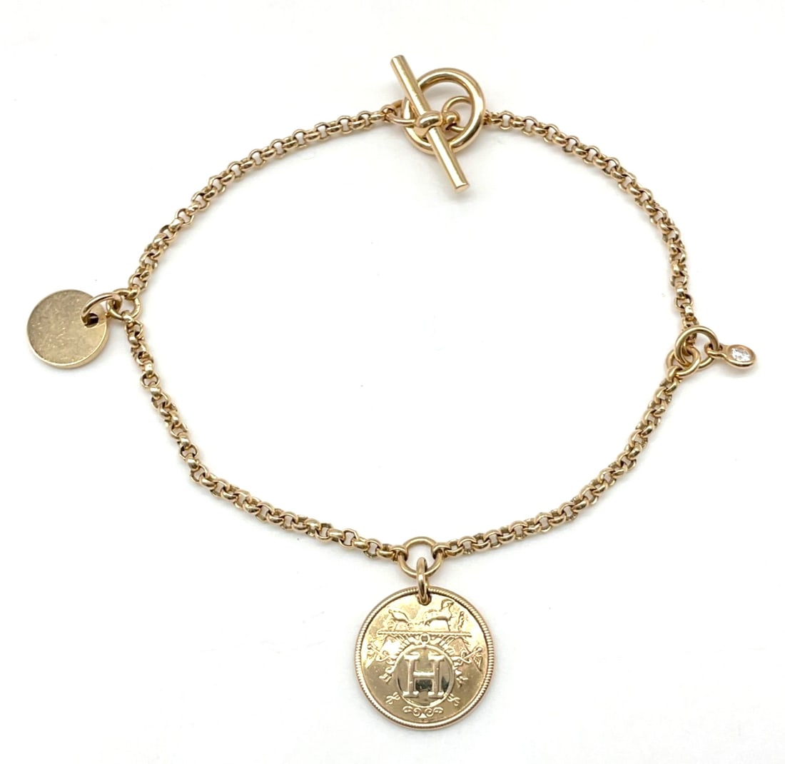 Hermes Ex Libris PM Diamond 0.04ct 18k Rose Gold Charm Bracelet Bangle 6.1 in: Hermes Ex Libris PM Diamond 0.04ct 18k Rose Gold Charm Bracelet Bangle 6.1 in 18k Rose Gold Charm Bangle with Round Diamond. This exquisite bangle features a round diamond, approximately 0.04 carats i