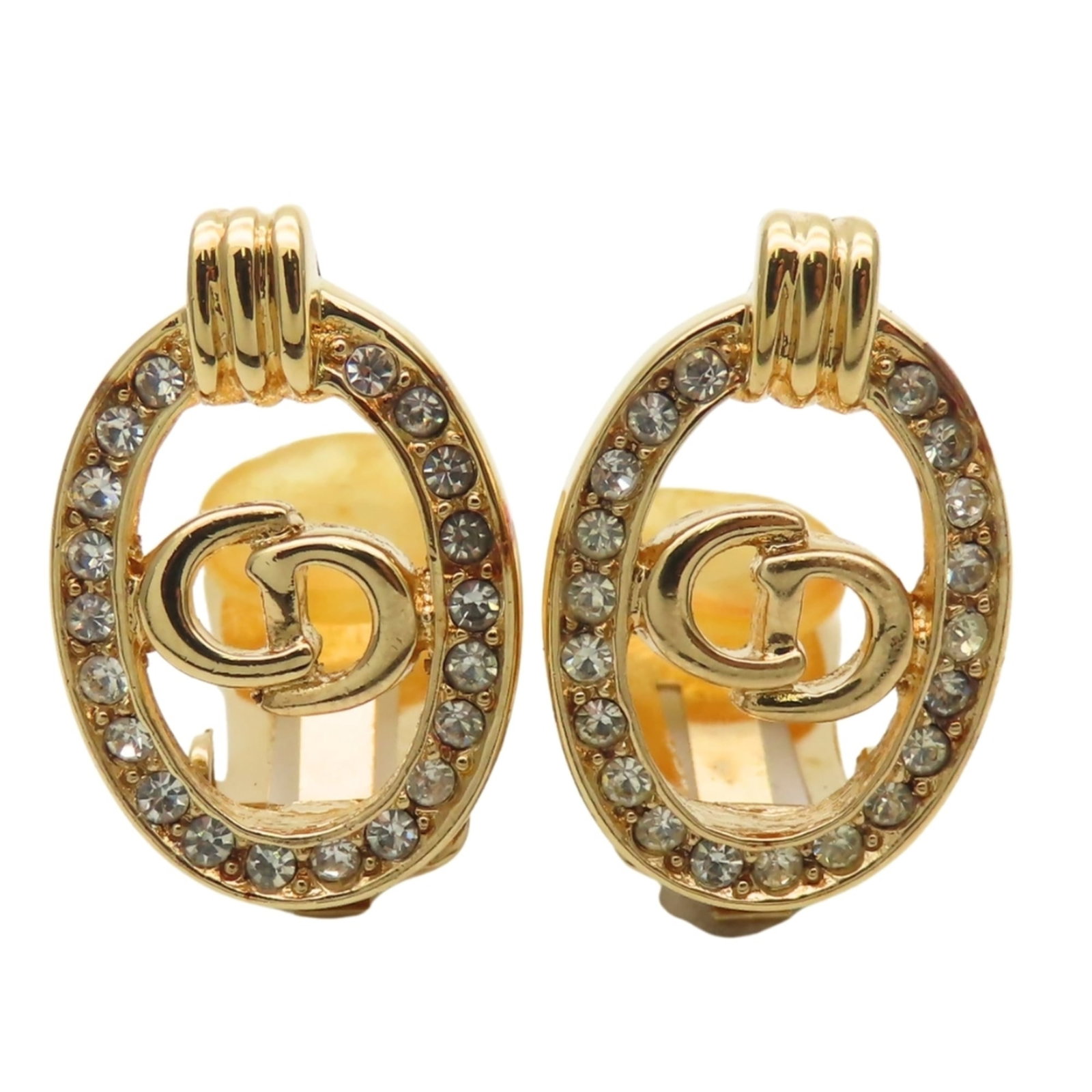 Metal clip earrings by Christian Dior: Metal clip earrings by Christian Dior Gold rhinestone clip earrings by Christian Dior, featuring a sleek metal design with a subtle sparkle from the rhinestones. The earrings are made from