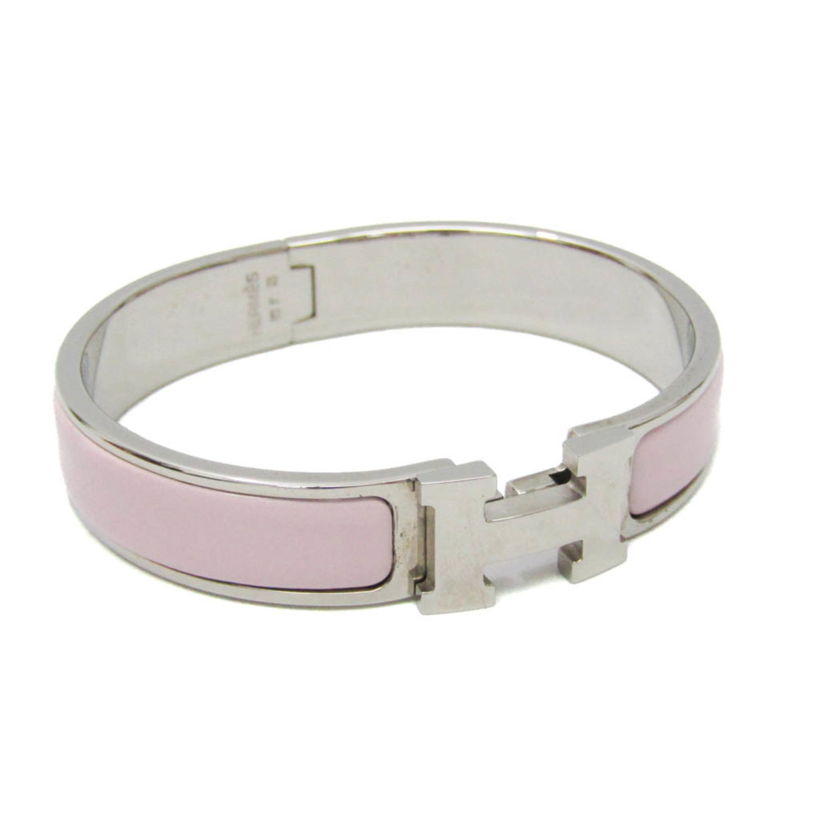Metal enamel bangle by Hermes: Metal enamel bangle by Hermes Metal enamel bangle by Hermes, featuring a light pink and silver finish, bears a few traces of usage with minor scratches and dirt. The bangle measures 15.5cm in length a