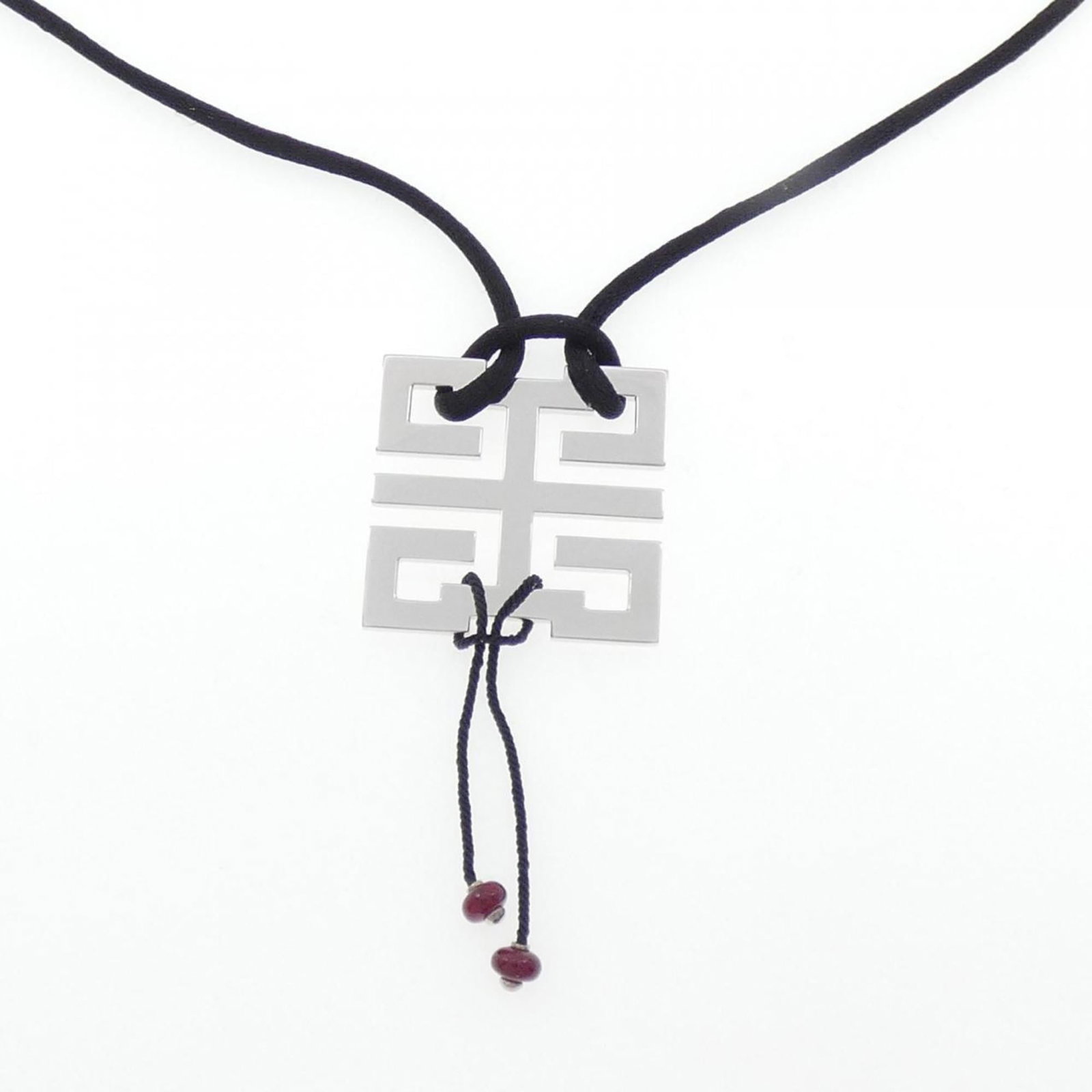 Knot Necklace by Cartier Wish: Knot Necklace by Cartier Wish A stunning Cartier Wish Knot Necklace in white gold, adorned with a vibrant ruby pendant. The necklace boasts a classic design with intricate details and a timeless