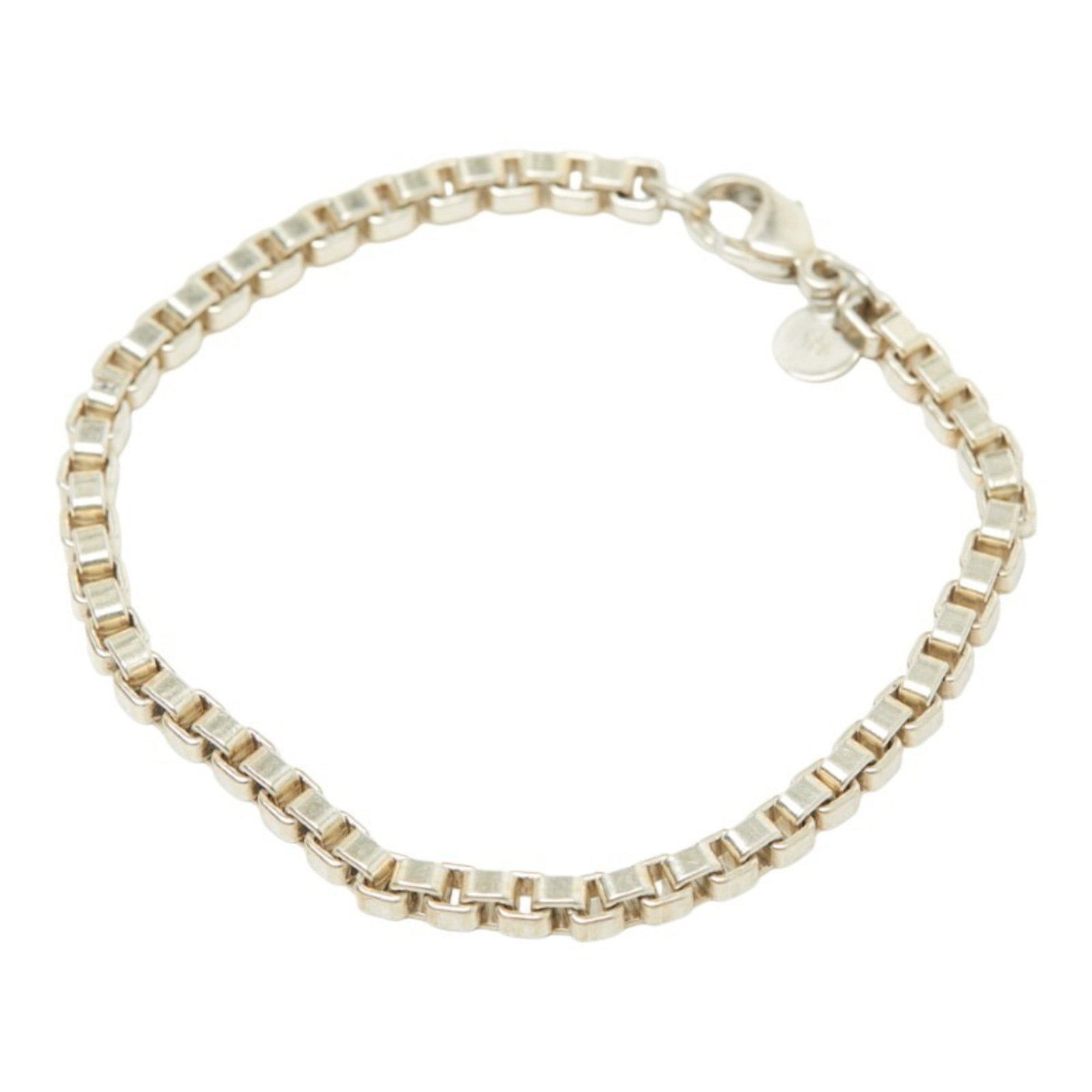 Silver 925 Tiffany Charm Bracelet: Silver 925 Tiffany Charm Bracelet Silver 925 Tiffany Charm Bracelet, featuring a classic design with subtle signs of wear from past use. The bracelet measures 18cm in length and showcases the sterling