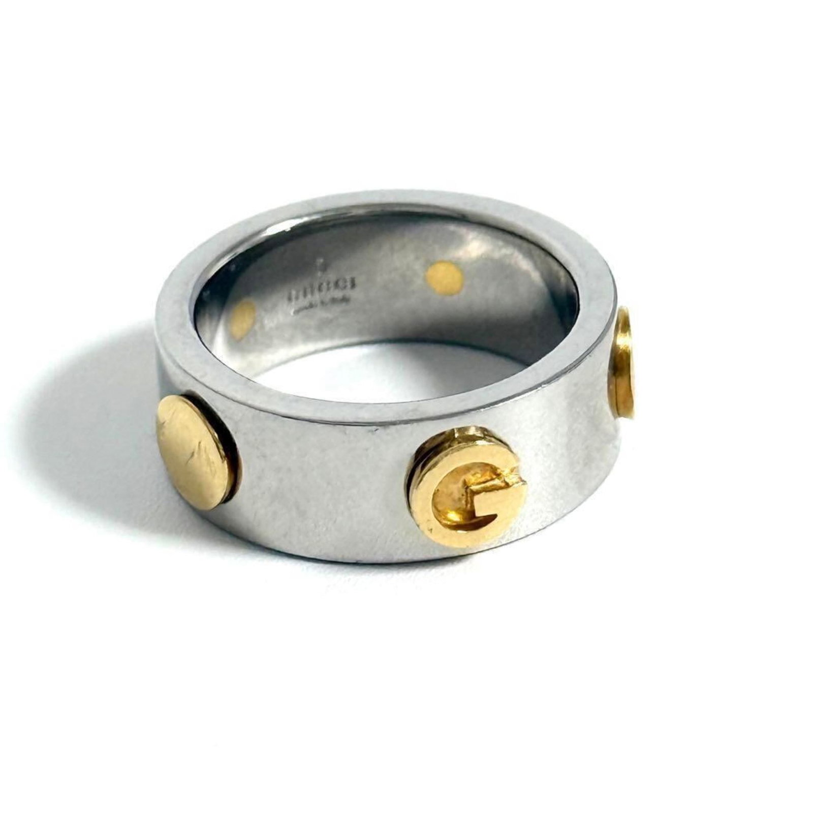 Gucci Band Ring Stainless Steel Yellow Gold: Gucci Band Ring Stainless Steel Yellow Gold Stainless Steel and Yellow Gold details make this Gucci Band Ring stand out, combining durability with luxurious finish. The ring's used condition shows som