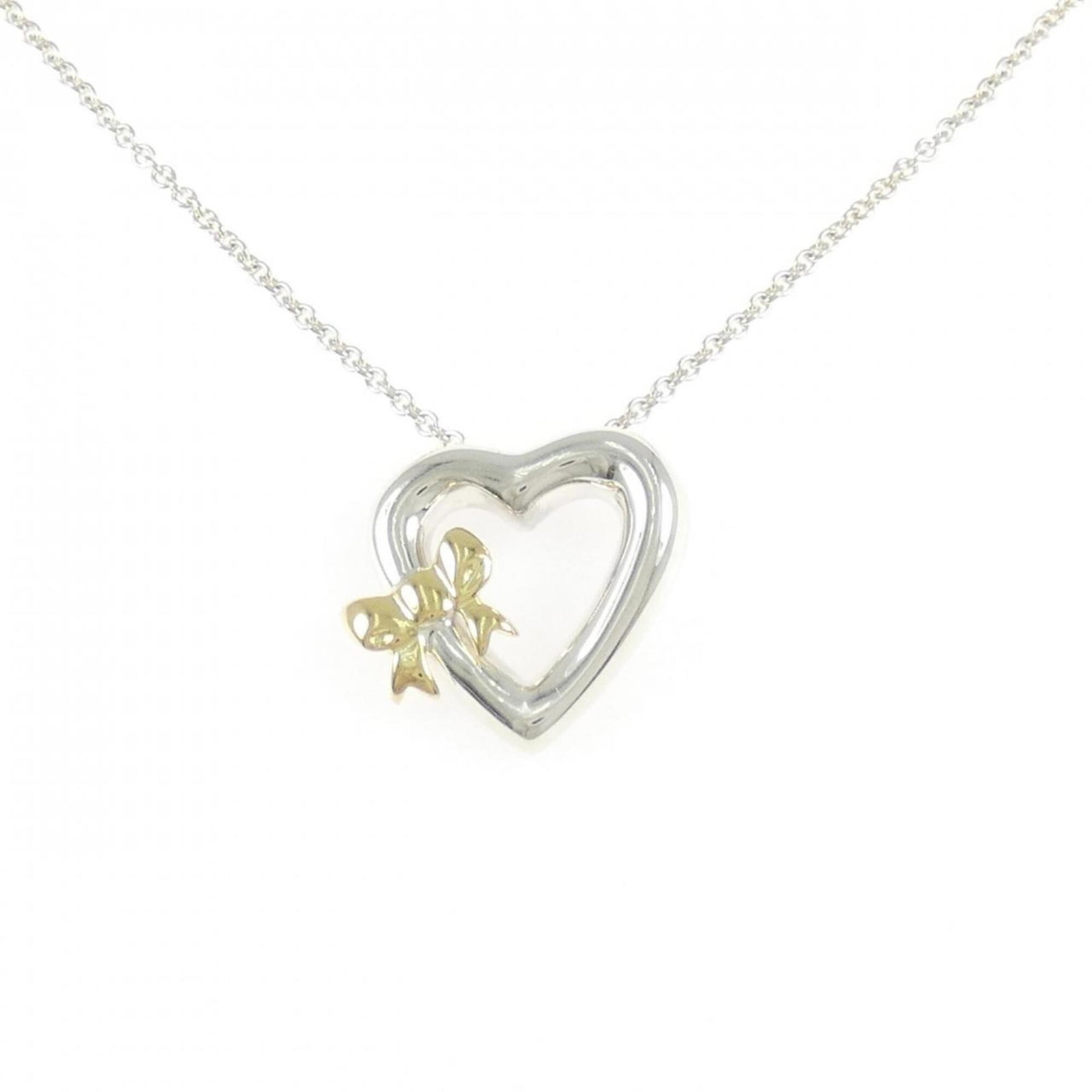 Tiffany & Co. 925 750Yg Necklace: Tiffany & Co. 925 750Yg Necklace Tiffany & Co.'s 925 silver and 18K yellow gold necklace boasts a striking pendant, measuring 18.8mm x 20.7mm, suspended from a chain with a comfortable 46 cm circumfer