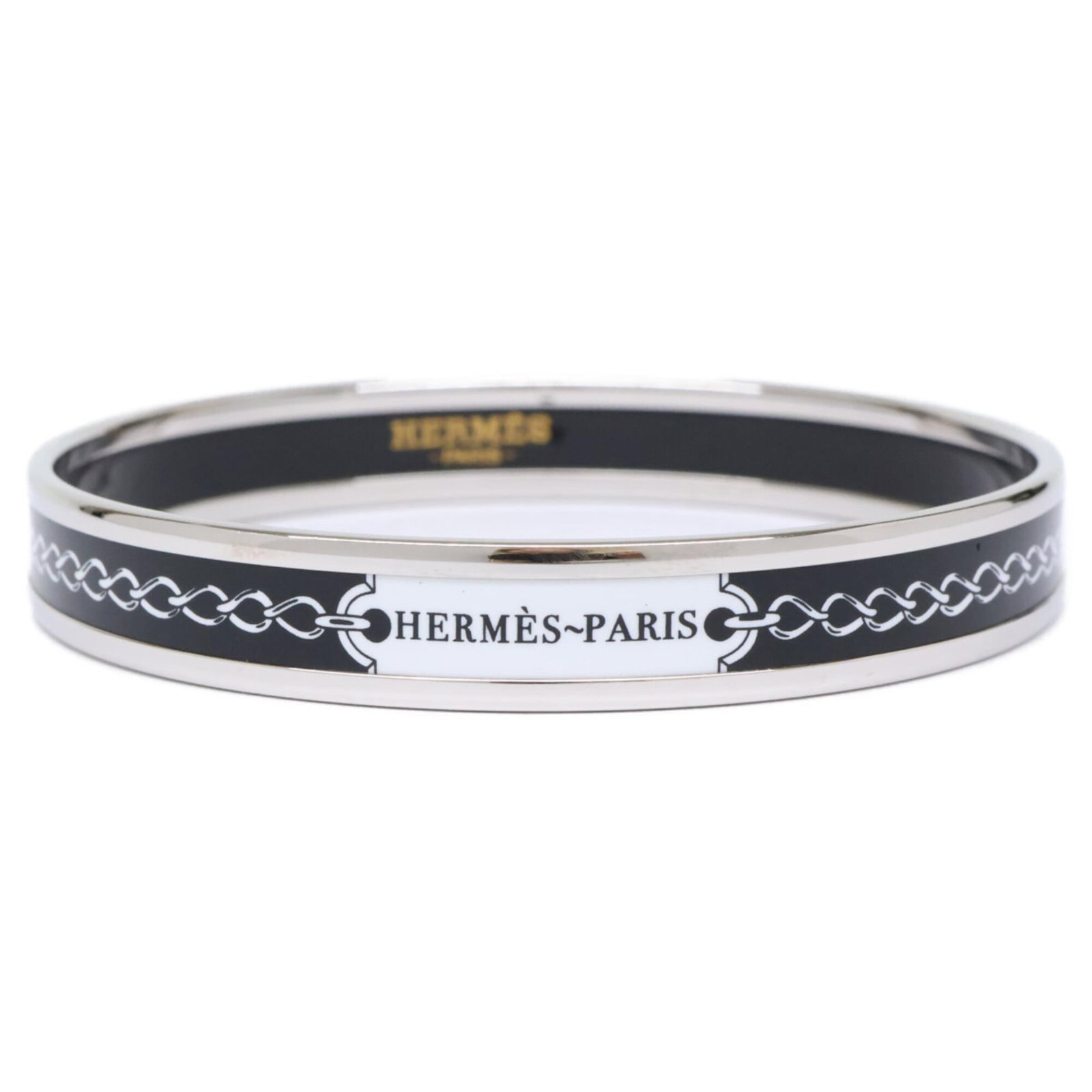 Metal Bangle Hermes: Metal Bangle Hermes A black, silver, and white metal bangle from the renowned luxury brand Hermes, measuring 19.5cm in length. This used item features a few traces of usage, with some scratches and di