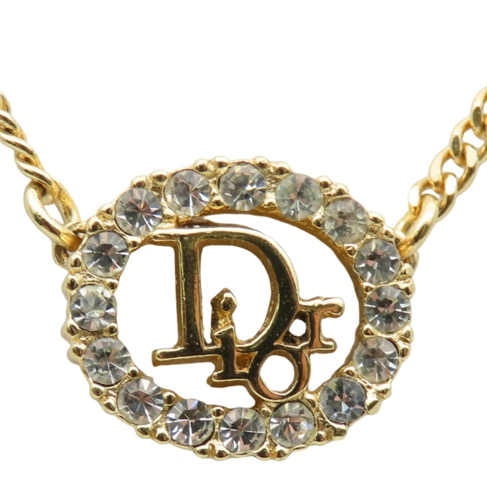 Christian Dior women necklace gold plated metal Cd logo.: Christian Dior women necklace gold plated metal Cd logo. Christian Dior gold plated metal Cd logo necklace features the iconic logo in rhinestone-studded gold, adding a touch of luxury to any outfit. 