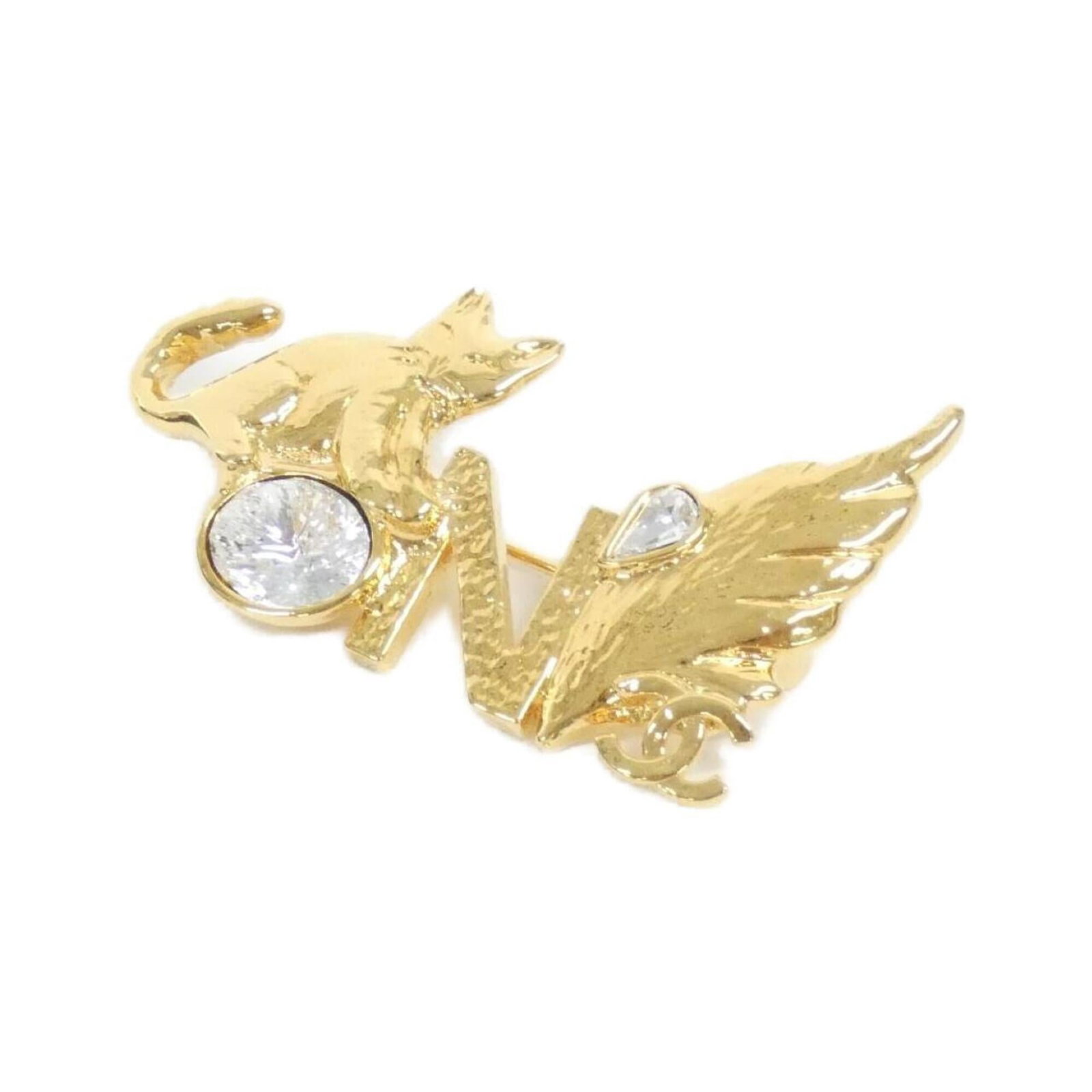 Chanel Brooch: Chanel Brooch Clear, gold Chanel brooch with a subtle sheen. Measuring 3cm x 5cm, it bears minor signs of usage, including a few scratches and some dirt, but remains in very good condition. Its