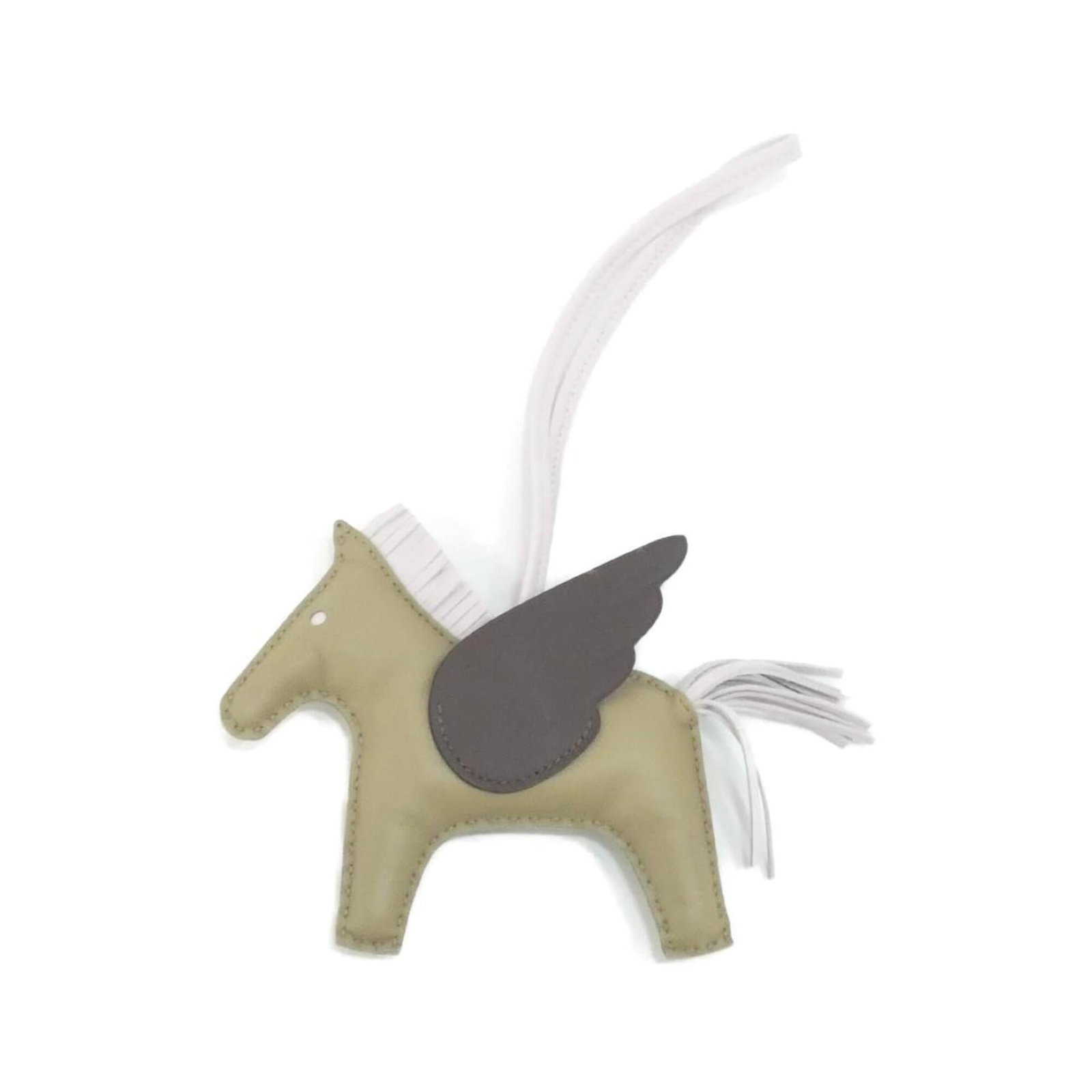 Hermes Handbag Charm Agneau Milo: Hermes Handbag Charm Agneau Milo Agneau Milo handbag charm from Hermes boasts a unique, earthy tone in beige and mocha hues. This used charm features some minor scratches and dirt, but remains in very