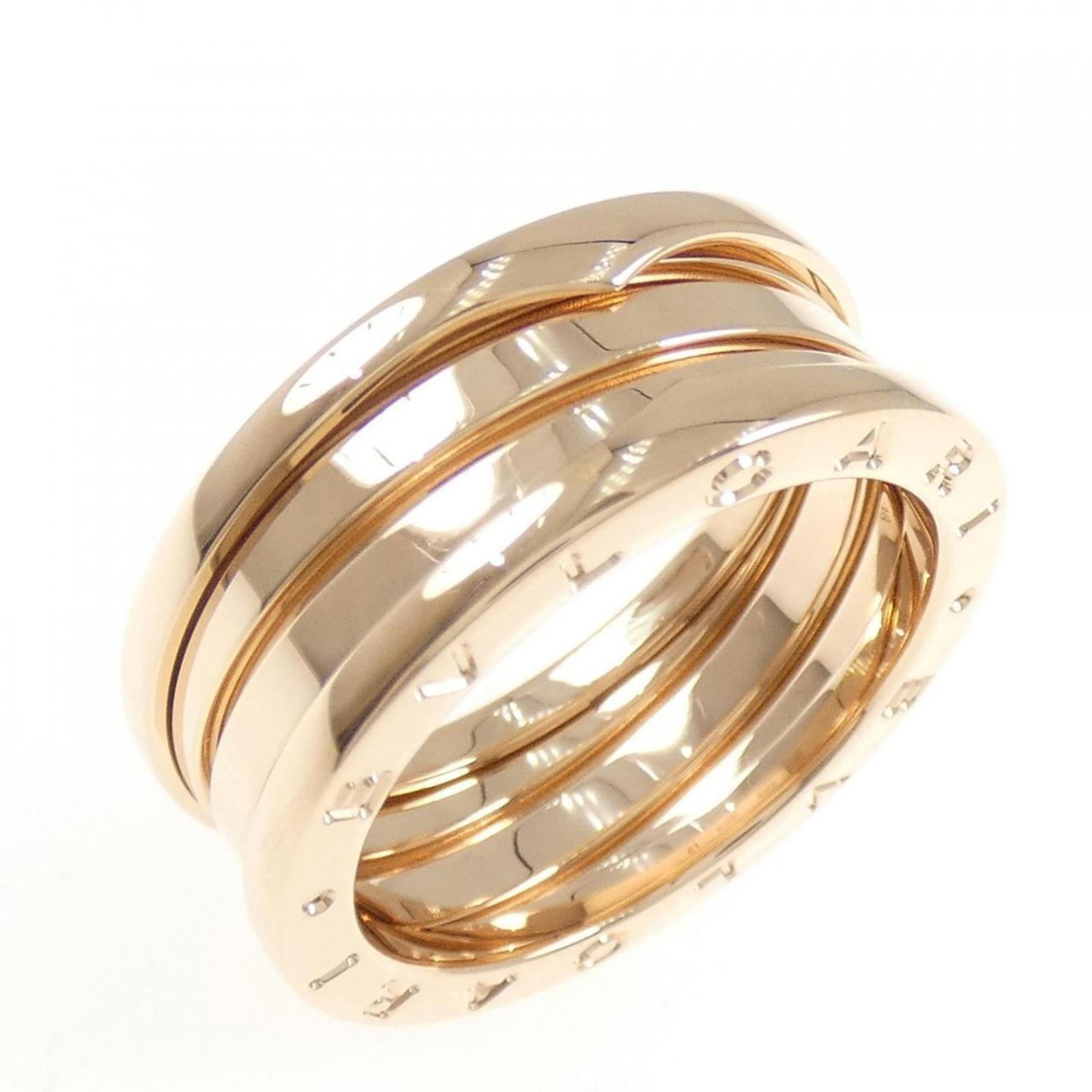 Pink Gold 18K Bvlgari Band Ring: Pink Gold 18K Bvlgari Band Ring Pink Gold 18K Bvlgari Band Ring features a distinctive pink gold band, characteristic of the luxury brand. The ring bears some traces of usage and minor scratches/dirt,
