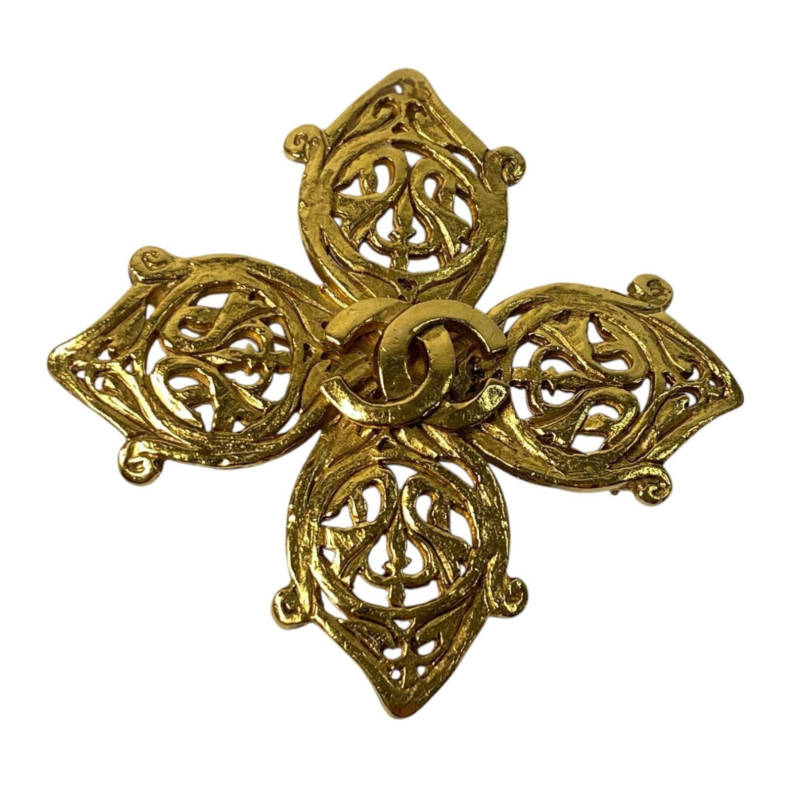 Chanel Brooch: Chanel Brooch Gold Chanel Brooch, measuring 5cm x 5cm, bears visible signs of usage with scratches and dirt. The brooch's condition is generally good despite these marks, making it a unique piece for 