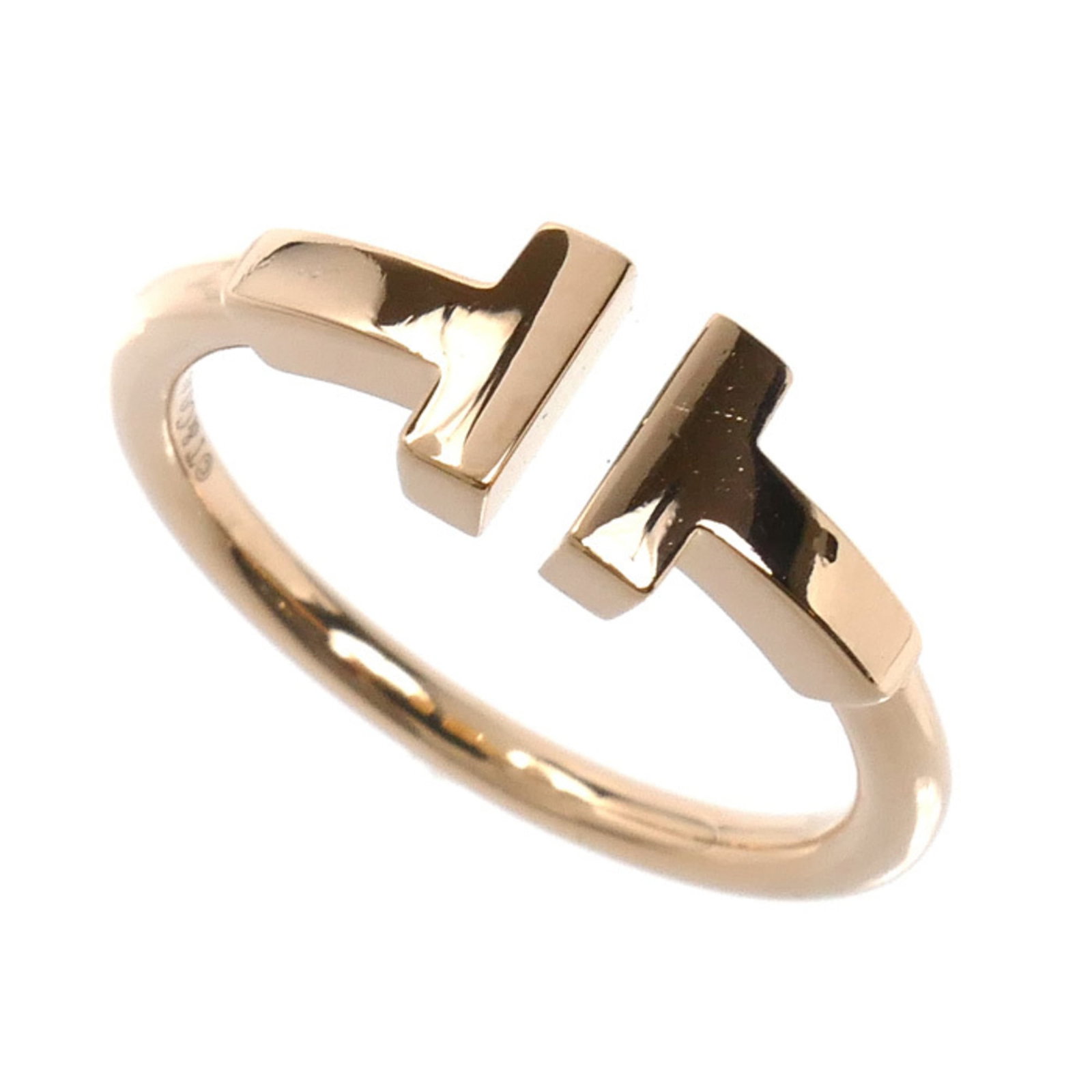 Pink Gold Ring Band Tiffany: Pink Gold Ring Band Tiffany Pink Gold Ring Band Tiffany, 18K material, women's size 5, with traces of usage and minor scratches. This used band ring features a subtle pink gold tone and bears a