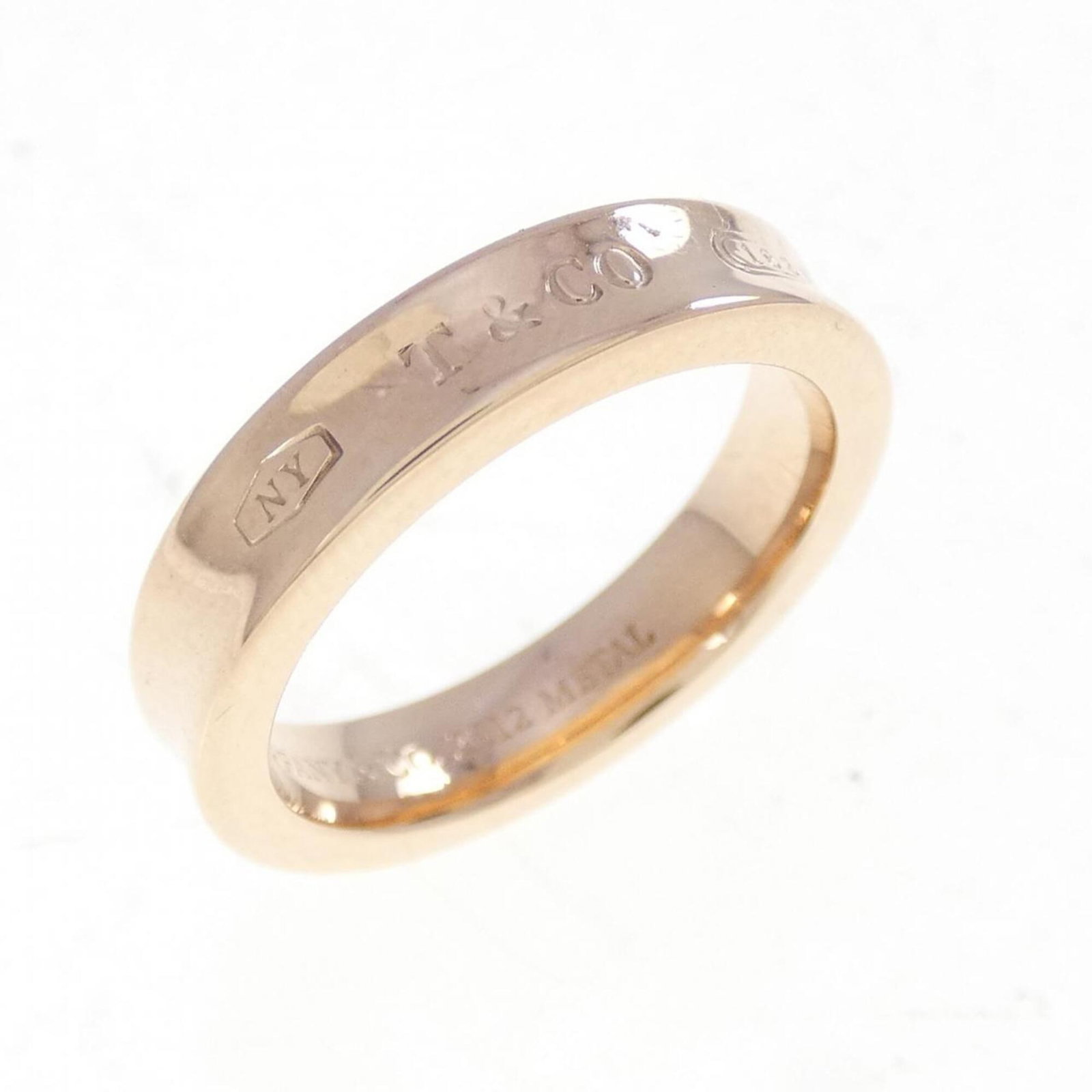 Gold Bronze Band Ring Silver Tiffany: Gold Bronze Band Ring Silver Tiffany Used (very good) Tiffany Type band ring in bronze, gold, and silver. The ring bears a few traces of usage, with some scratches and dirt visible, but remains in ver
