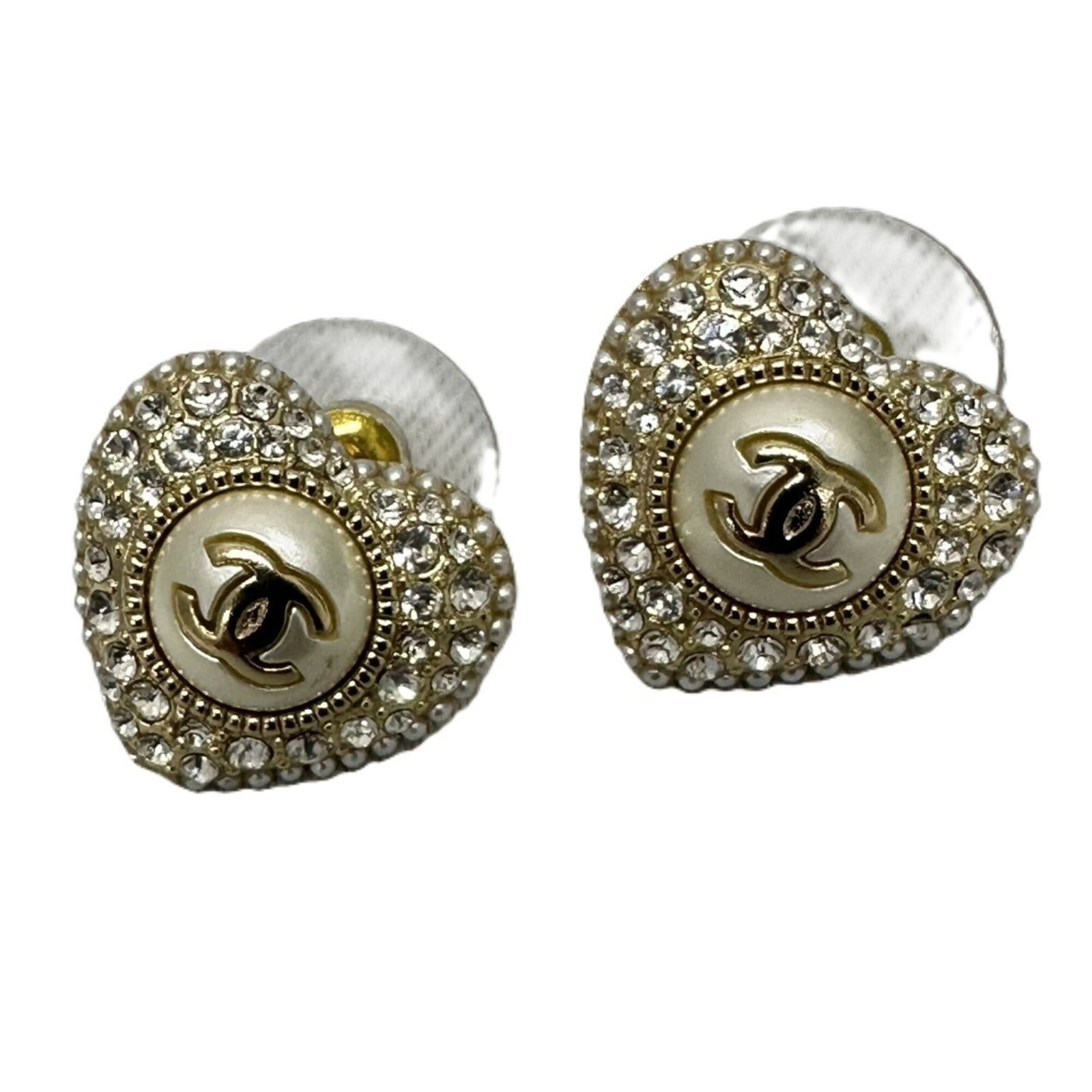 Chanel Stud Earrings: Chanel Stud Earrings Chanel's iconic stud earrings feature crisp white crystals set against a sleek metal frame, adding a touch of timeless elegance to any outfit. These used earrings showcase some mi