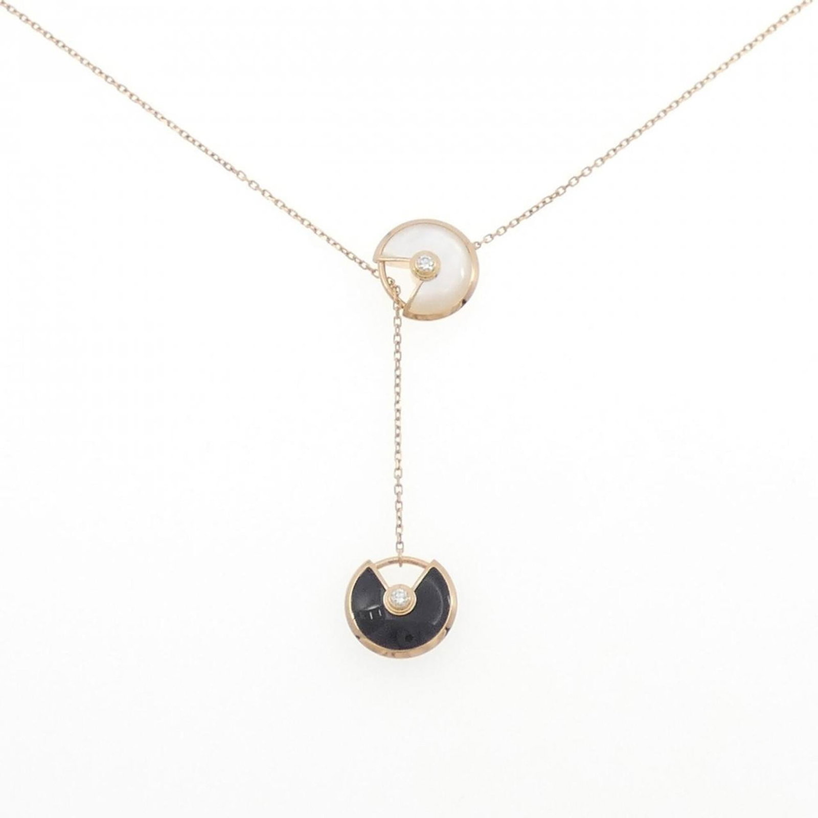 Amulet Necklace By Cartier: Amulet Necklace By Cartier Pink Gold (18K) Amulet Necklace by Cartier features a unique combination of diamond, mother of pearl, and onyx stones. The necklace boasts a 60 cm length with a pendant