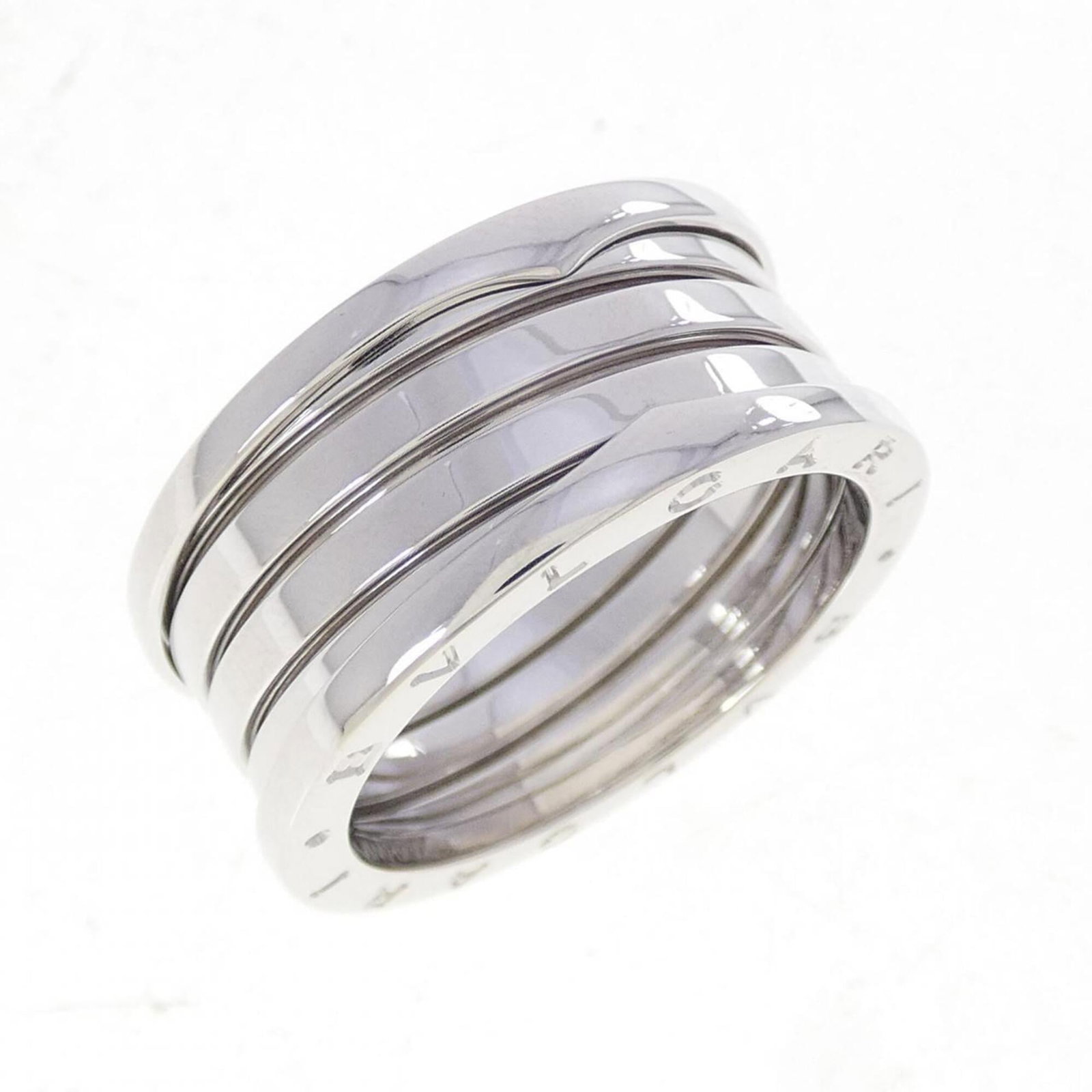 Bvlgari Band Ring White Gold (18K): Bvlgari Band Ring White Gold (18K) Bvlgari Band Ring White Gold (18K) features a sleek, modern design with 18K white gold construction. The ring boasts a few traces of usage, some scratches and dirt v