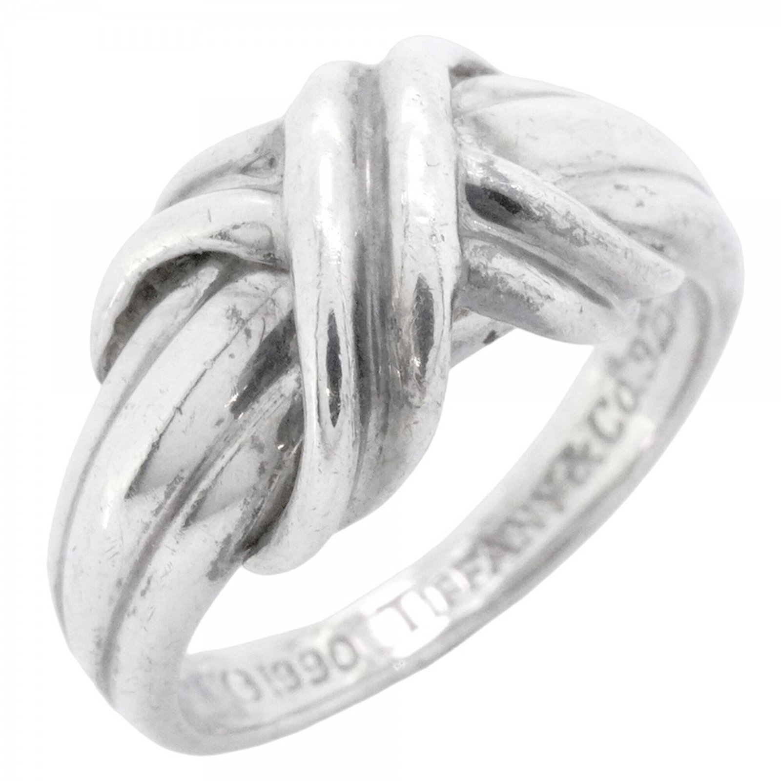 Tiffany Band Ring Silver 925: Tiffany Band Ring Silver 925 Silver 925 band ring from Tiffany, featuring a classic design with subtle wear and minor scratches. The item bears the brand's mark and has been used, showing signs of gen