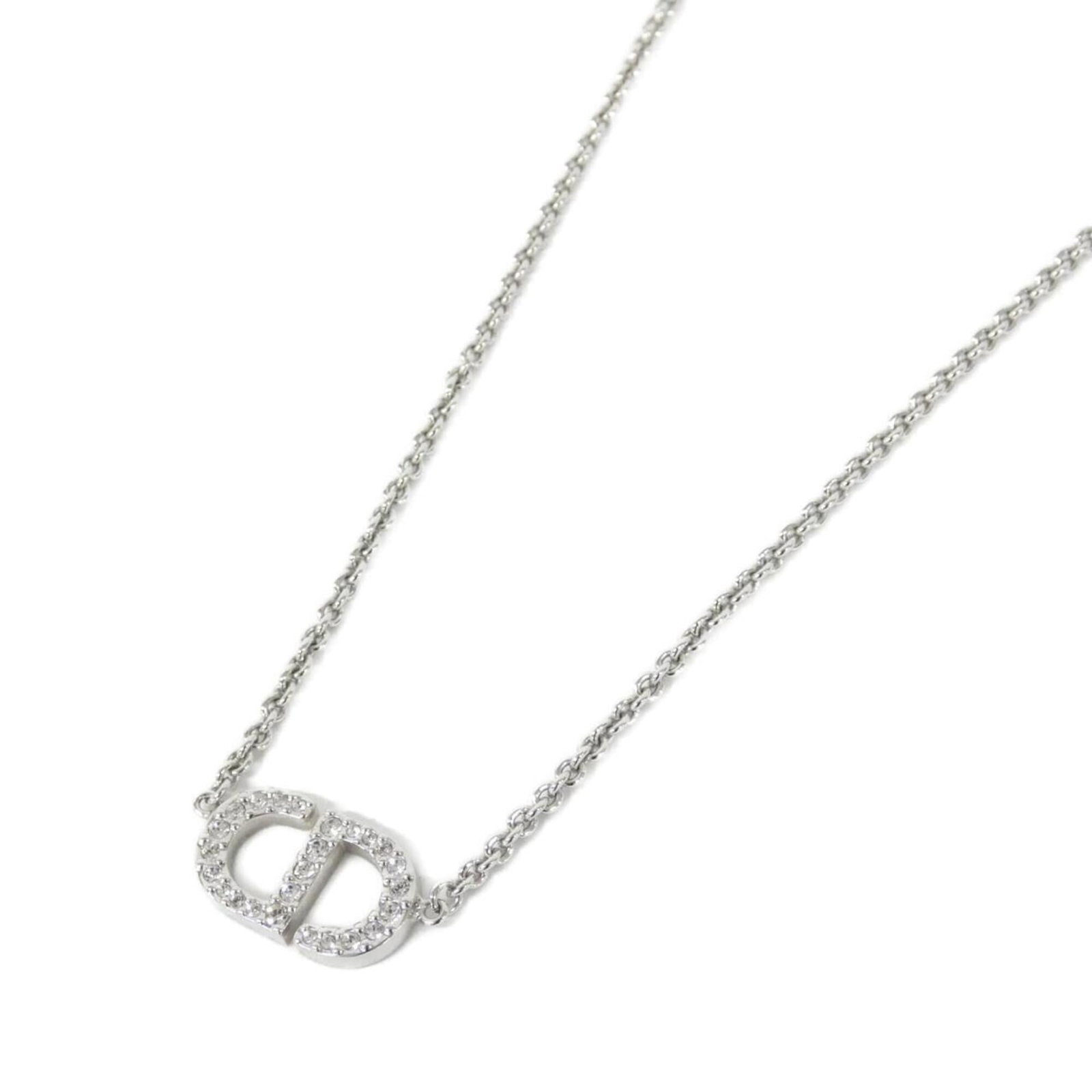 Christian Dior Petite Cd N2241Womcy Necklace: Christian Dior Petite Cd N2241Womcy Necklace The Christian Dior Petite Cd Necklace boasts a sleek, clear crystal pendant set against a silver backdrop. Its petite size and delicate design make it a