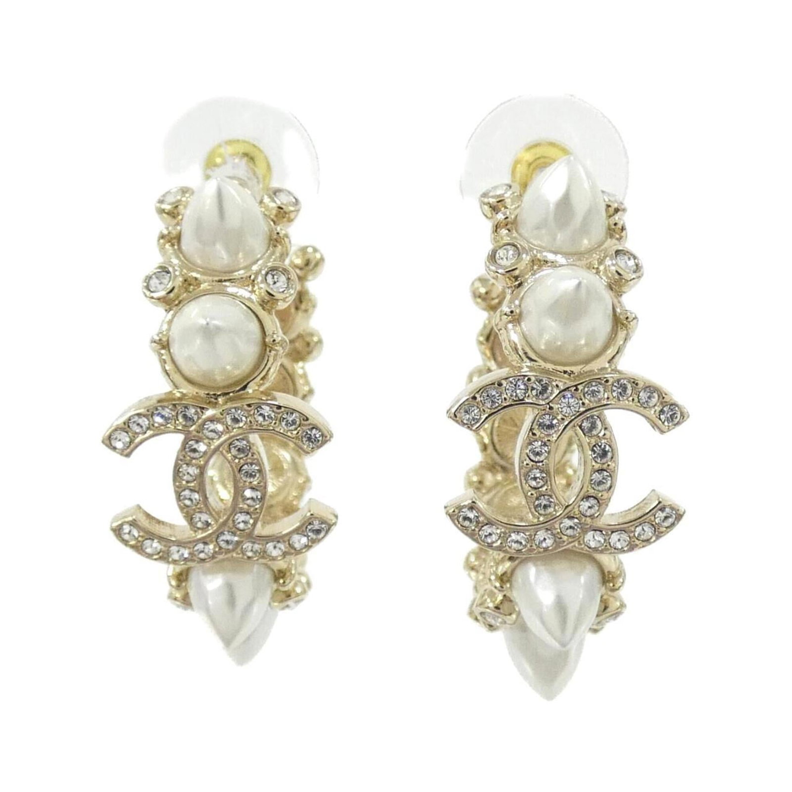 Hoop Earrings by Chanel: Hoop Earrings by Chanel Chanel's iconic hoop earrings, featuring a crisp white crystal stone set in a sleek metal frame, add a touch of timeless elegance to any outfit. With their classic design and s