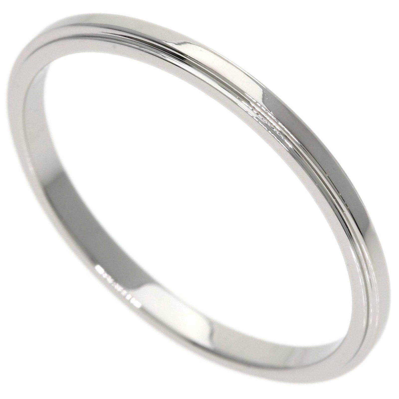 Ring Band by Platinum 950: Ring Band by Platinum 950 Platinum 950 band ring by Cartier, featuring a sleek and sophisticated design. The ring bears a few traces of usage, with some scratches and dirt visible, but remains in very