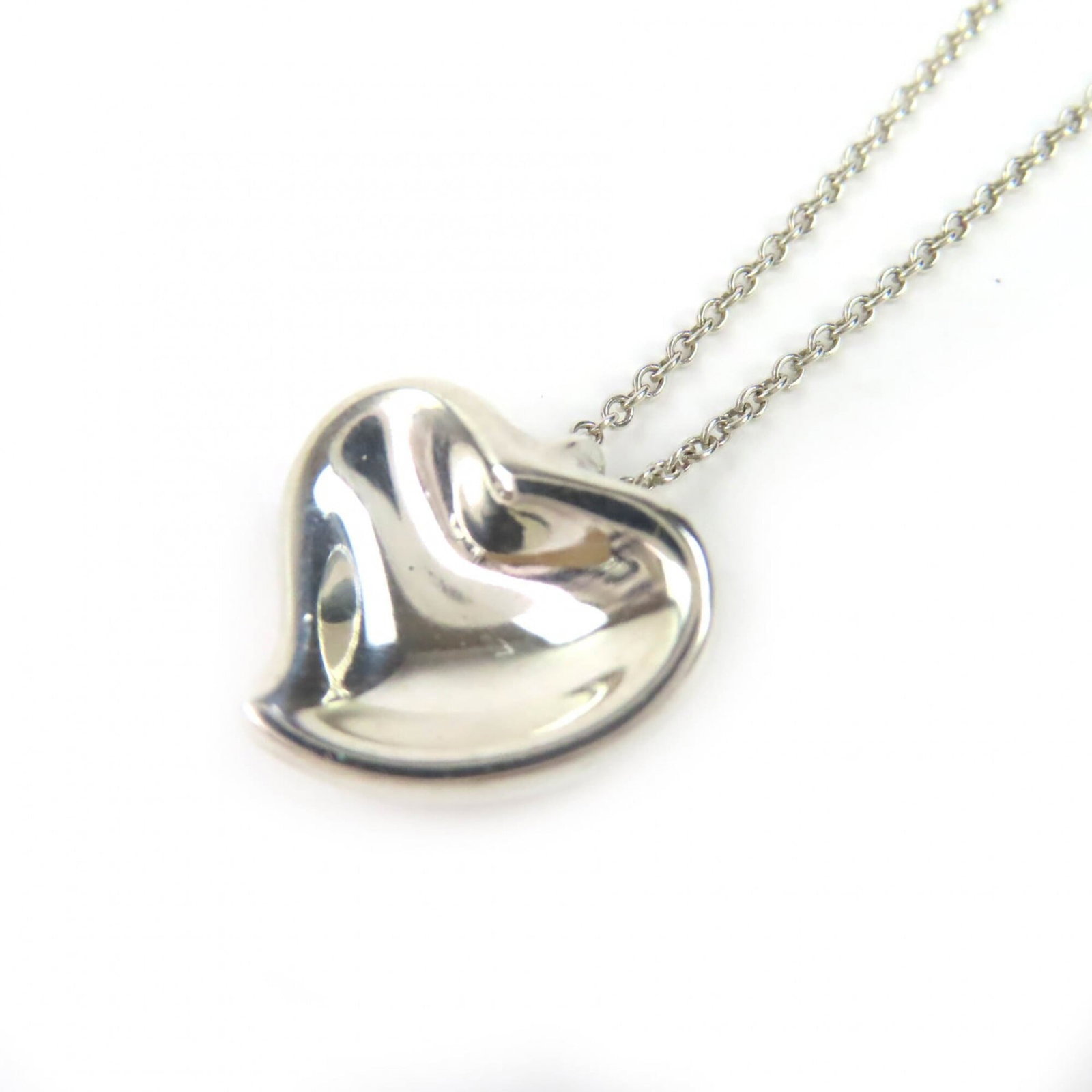 Tiffany&Co. Tiffany & Co. Elsa Peretti Curved Heart Necklace 925 Sterling Silver Made In Spain: Tiffany&Co. Tiffany & Co. Elsa Peretti Curved Heart Necklace 925 Sterling Silver Made In Spain Tiffany & Co.'s Elsa Peretti Curved Heart Necklace is a stunning piece made from 925 sterling silver, cra