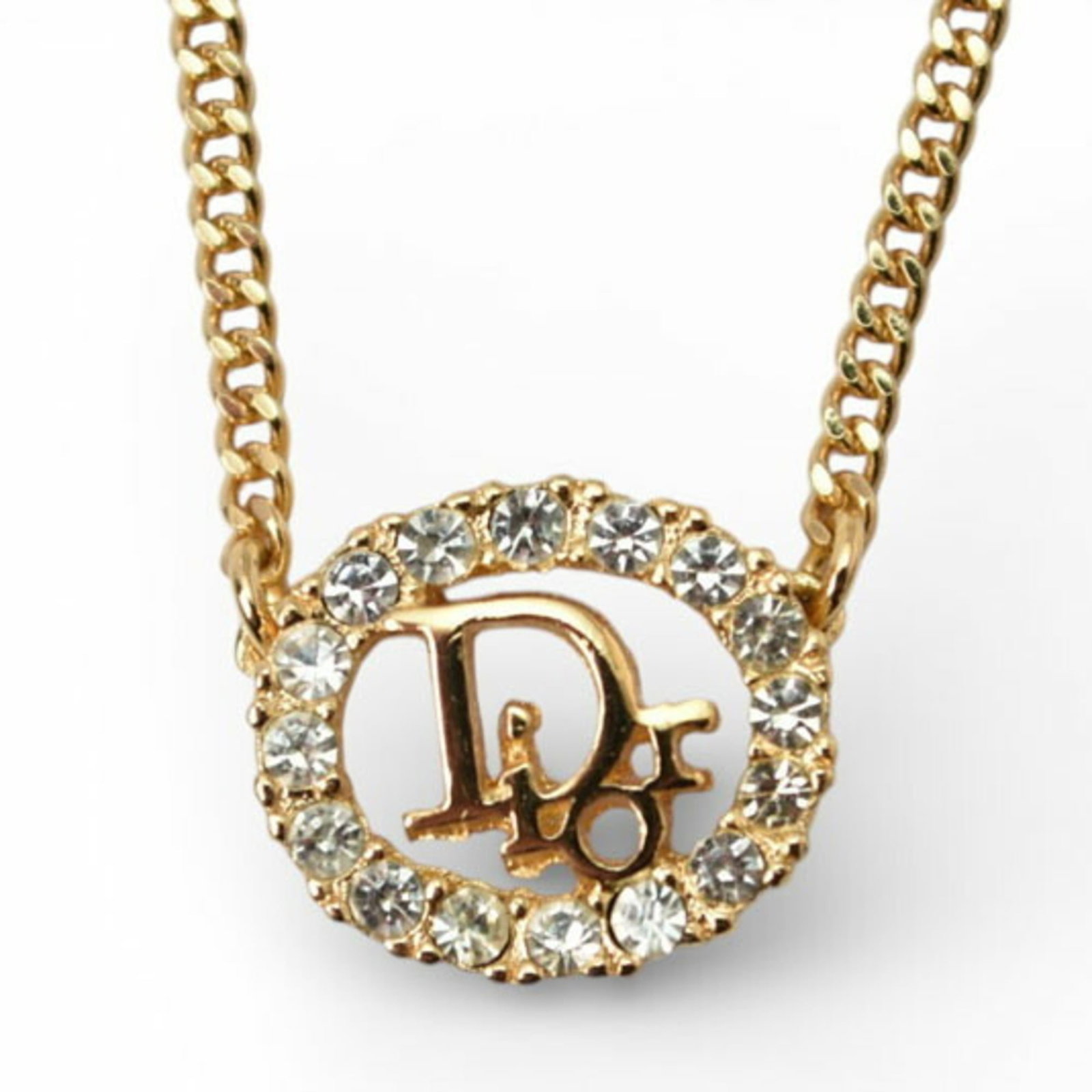 Dior necklace gold rhinestone Christian: Dior necklace gold rhinestone Christian Gold plated Dior necklace featuring rhinestone pendant, available in sizes to fit necks from 14.56'' to 16.53''. The necklace boasts a classic design with a