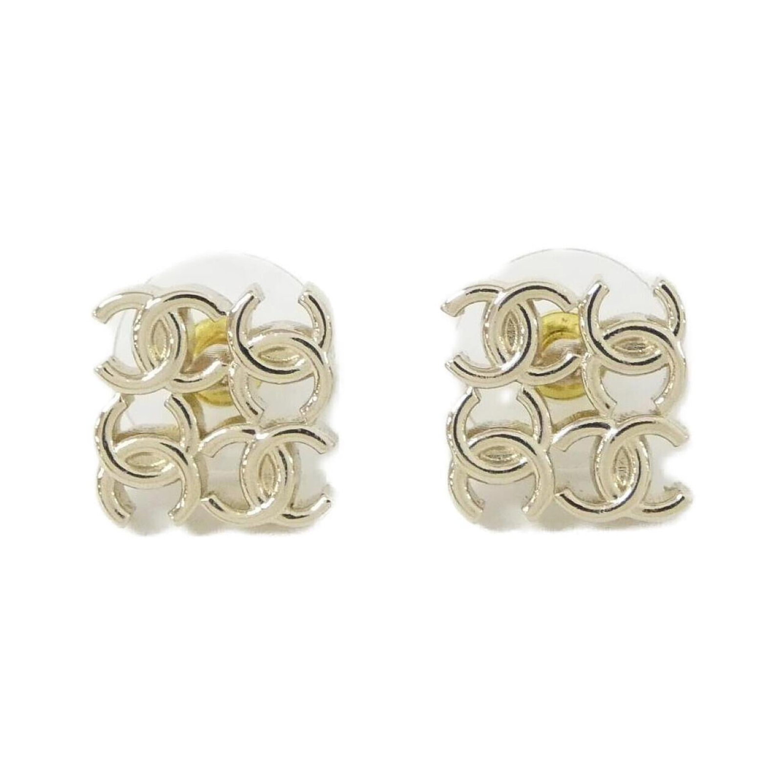 Chanel Stud Earrings: Chanel Stud Earrings Gold stud earrings from the iconic Chanel brand, featuring a sleek and timeless design. The earrings have a few traces of usage, with some minor scratches and dirt visible, but re