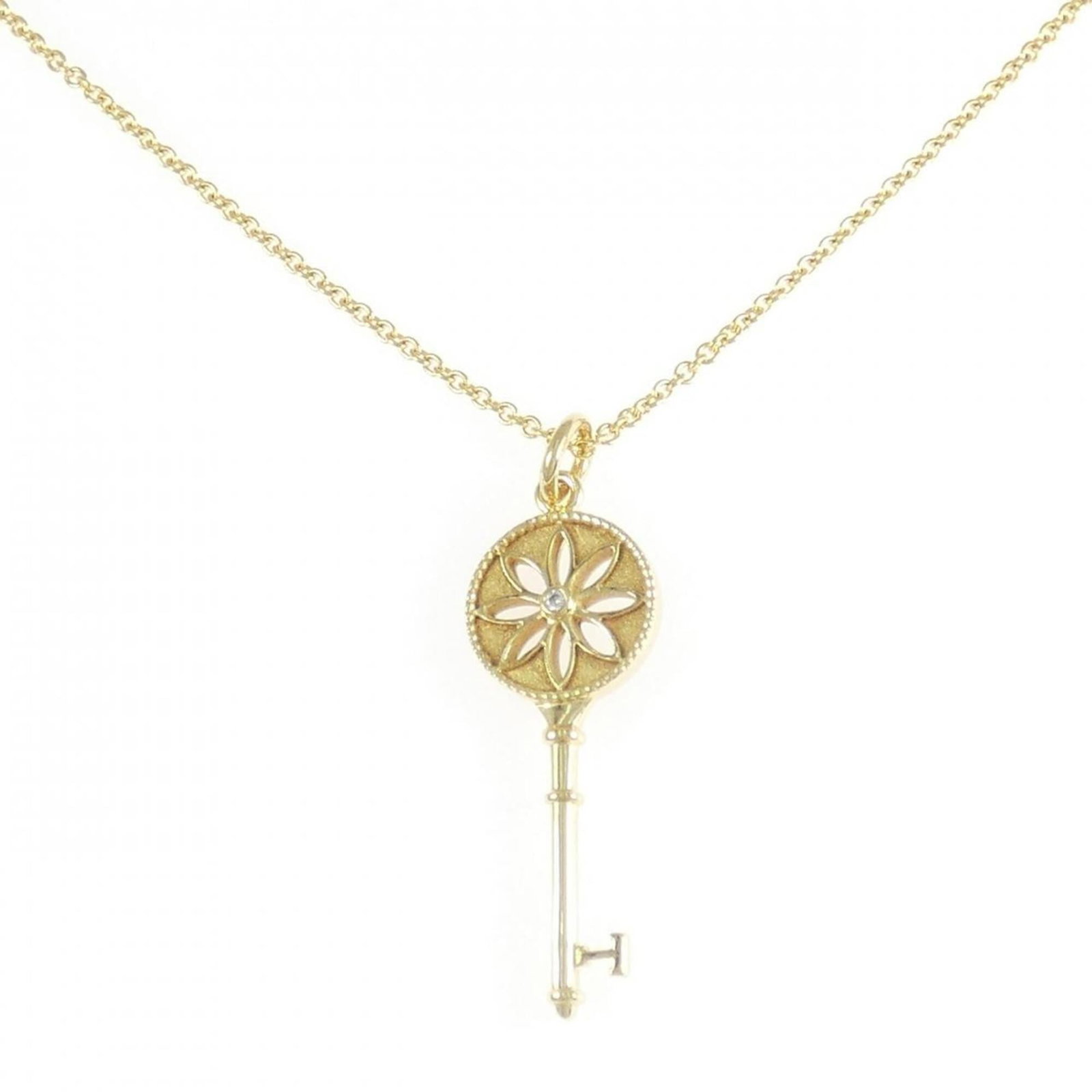 Daisy Key Necklace by Tiffany: Daisy Key Necklace by Tiffany Yellow gold pendant necklace featuring a diamond, crafted by Tiffany. The necklace boasts a classic design with a 46 cm circumference and a pendant size of 39.2mm x 12mm,