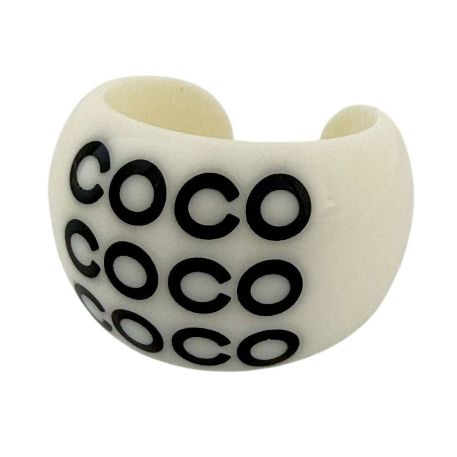 Ring Plastic Chanel Band: Ring Plastic Chanel Band This used Chanel band ring features a plastic material and a classic design. With some minor scratches and dirt, it retains its original condition despite being worn. The ring