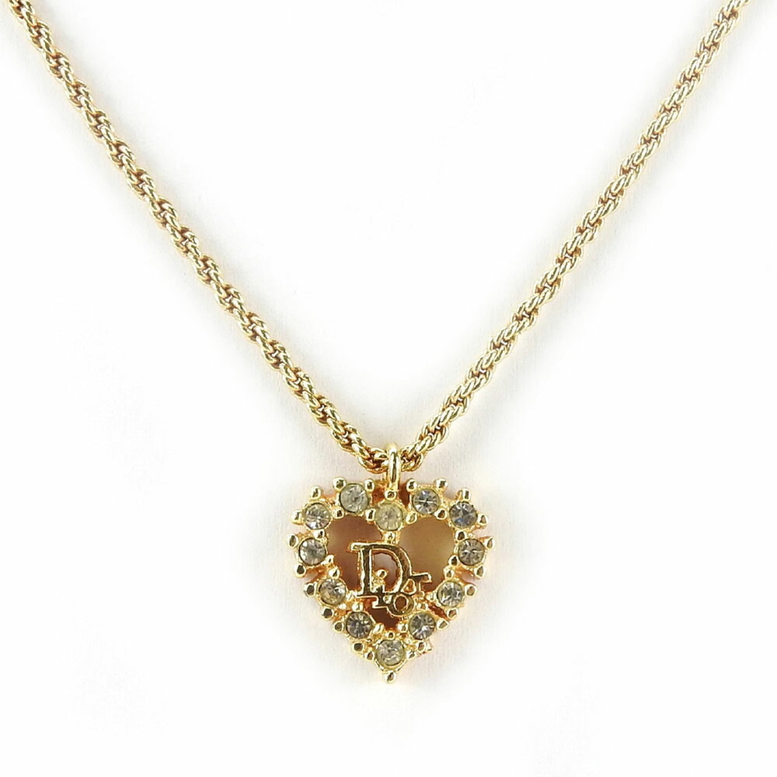 Christian Dior Women's Rhinestone Heart Gold Necklace Metal: Christian Dior Women's Rhinestone Heart Gold Necklace Metal Gold rhinestone heart pendant on a gold metal chain, bearing the signature of Christian Dior. This elegant necklace features a delicate