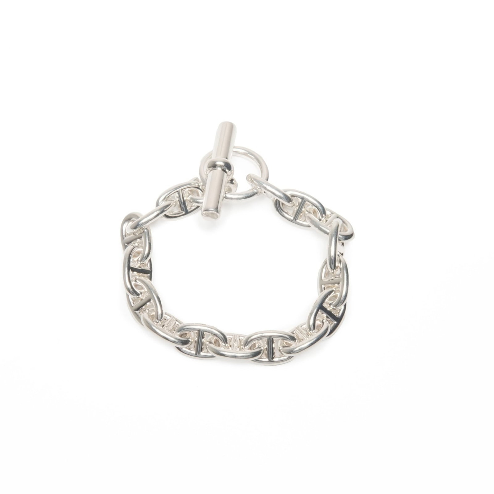 Charm Bracelet by Hermes: Charm Bracelet by Hermes Silver Charm Bracelet by Hermes, measuring 17cm in length, features subtle traces of usage and minor scratches. The bracelet's silver finish remains in very good condition, wi