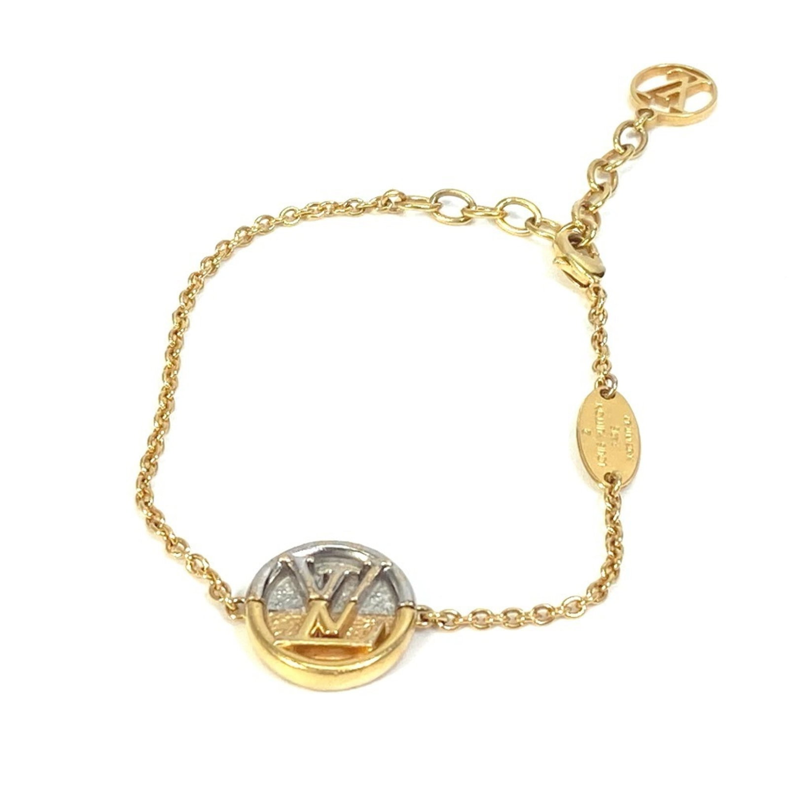 Charm of Louis Vuitton Metal: Charm of Louis Vuitton Metal Gold and Silver Louis Vuitton Metal Charm Bracelet. This 18.5cm gold and silver charm bracelet features the iconic Louis Vuitton metal design, bearing traces of usage