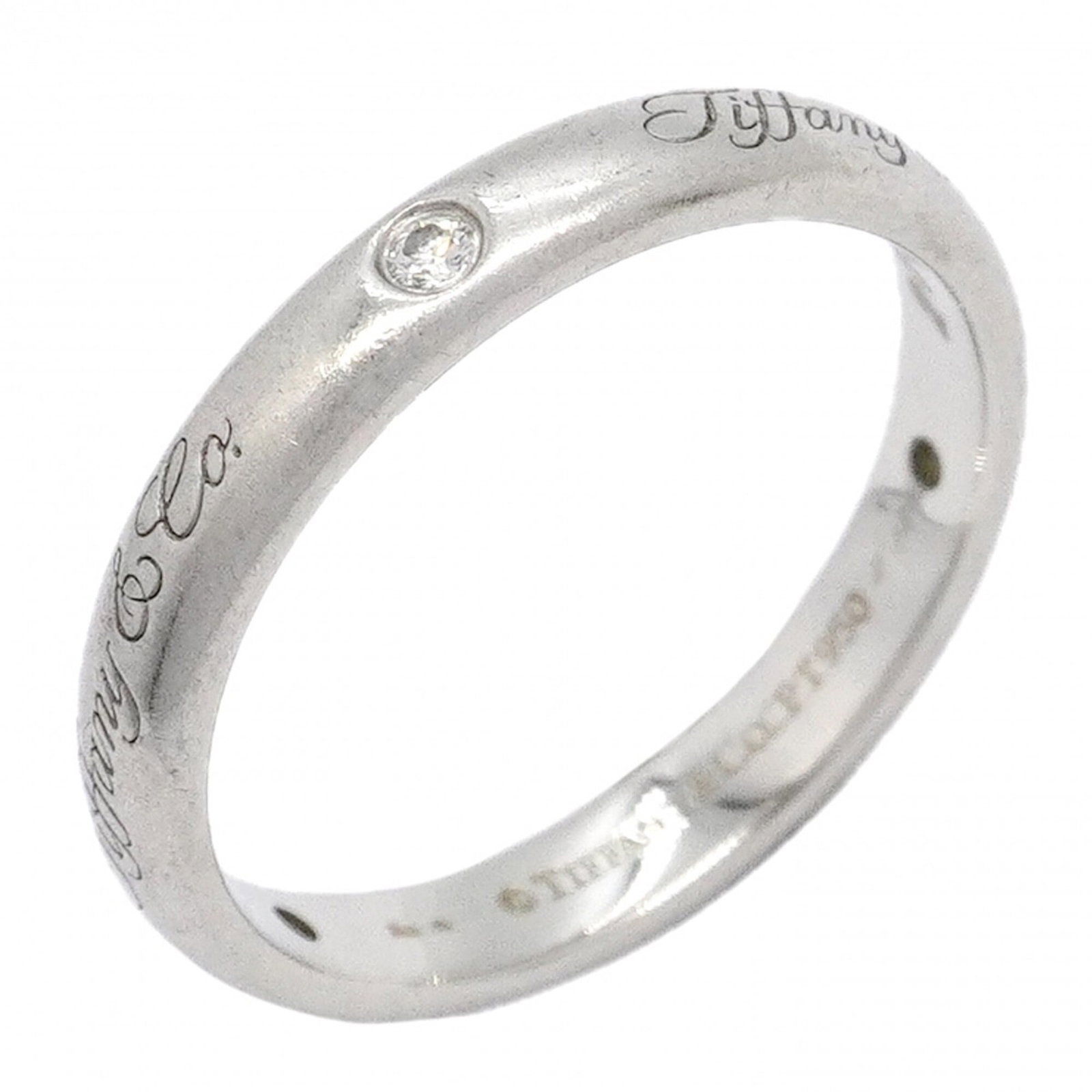 Platinum ring by Tiffany band: Platinum ring by Tiffany band Platinum ring by Tiffany & Co. features a diamond stone set in a classic band design, crafted from high-quality platinum material. The ring bears the signature of Tiffany