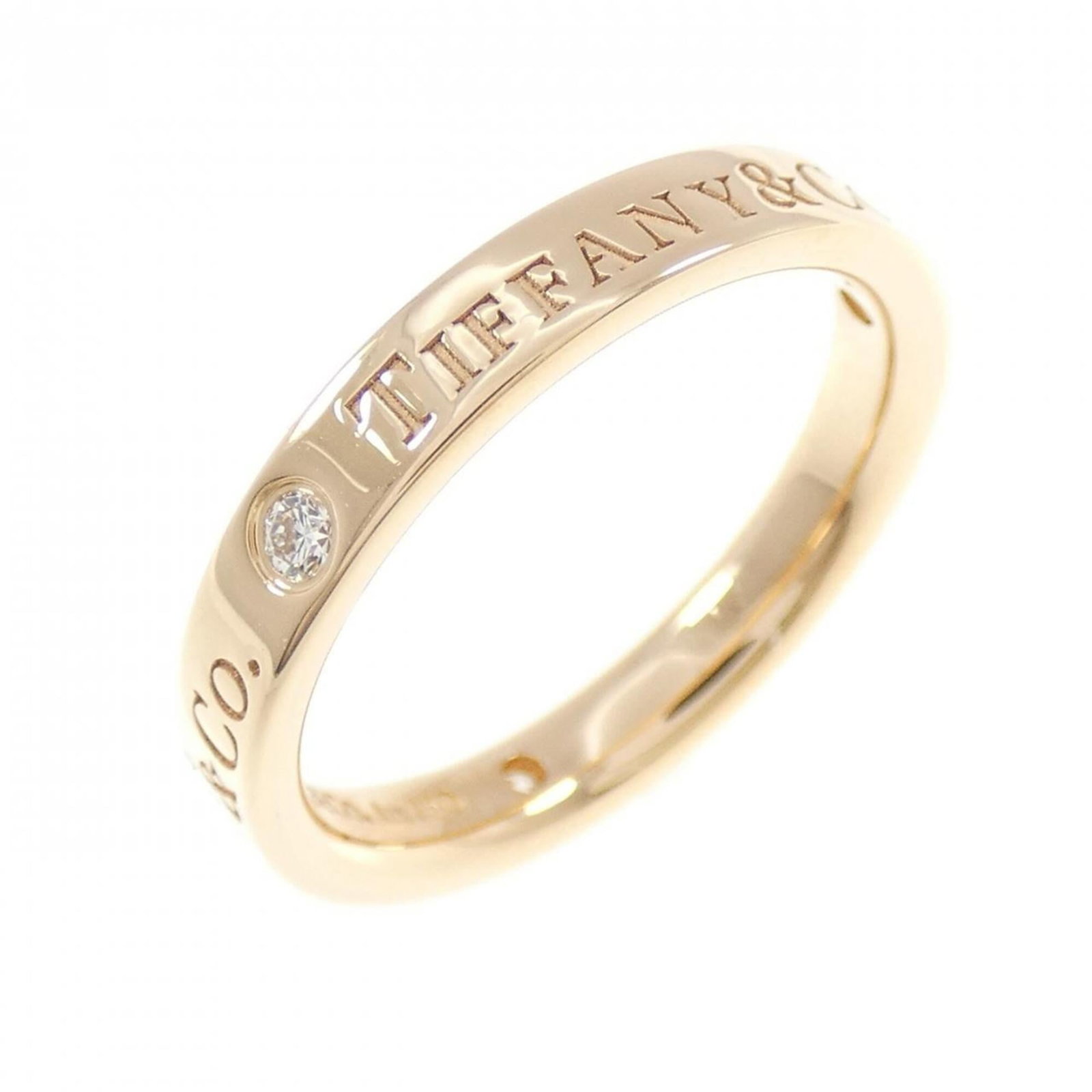 Pink Gold Ring Band Tiffany: Pink Gold Ring Band Tiffany Pink Gold Ring Band from Tiffany features a diamond stone set in an 18K pink gold band, available in size 5. The ring showcases some signs of usage, with minor scratches an