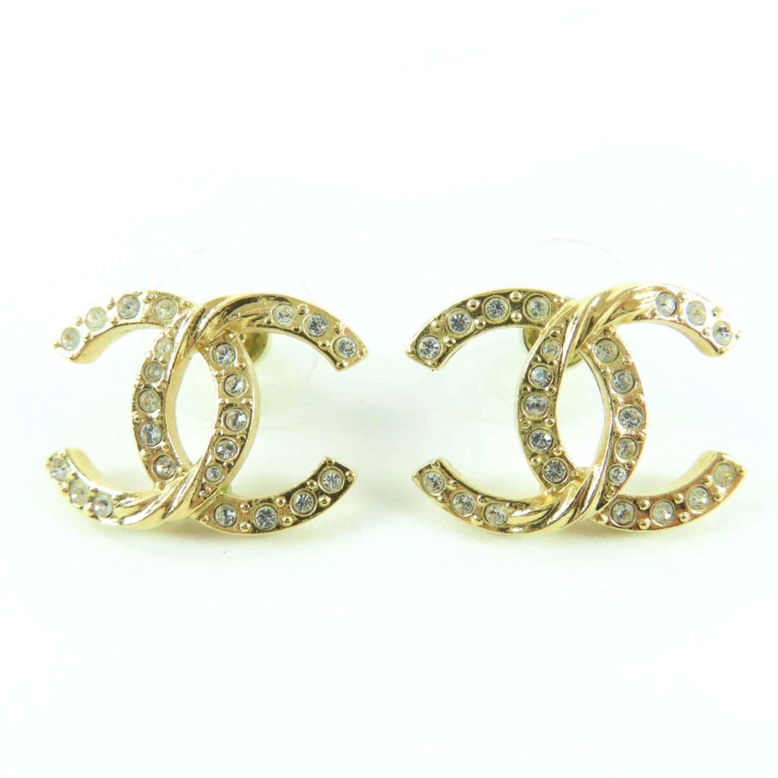 Chanel Stud Earrings: Chanel Stud Earrings Chanel Stud Earrings in Gold, featuring rhinestone accents. The earrings showcase a classic design with a 15mm x 20mm Rhinestone stone. In very good condition, with some minor