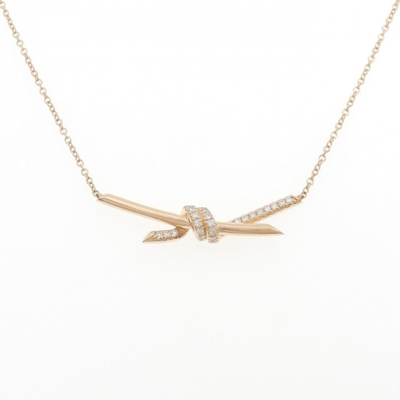 Tiffany Knot Necklace 0.25Ct: Tiffany Knot Necklace 0.25Ct Pink Gold (18K) Tiffany Knot Necklace with a 0.25Ct Diamond Pendant, featuring a classic and elegant design that adds a touch of sophistication to any outfit. The