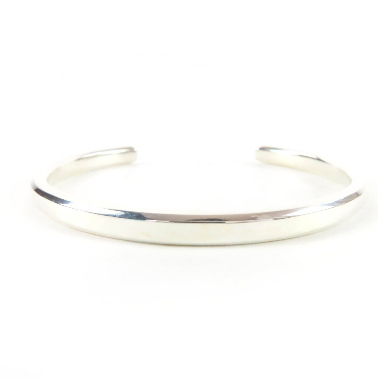 Tiffany Bangle: Tiffany Bangle Silver Tiffany Bangle, 14cm in length with a subtle 4mm width, bearing the hallmark of Silver925. This bangle has been used and shows some signs of wear, including minor scratches and d