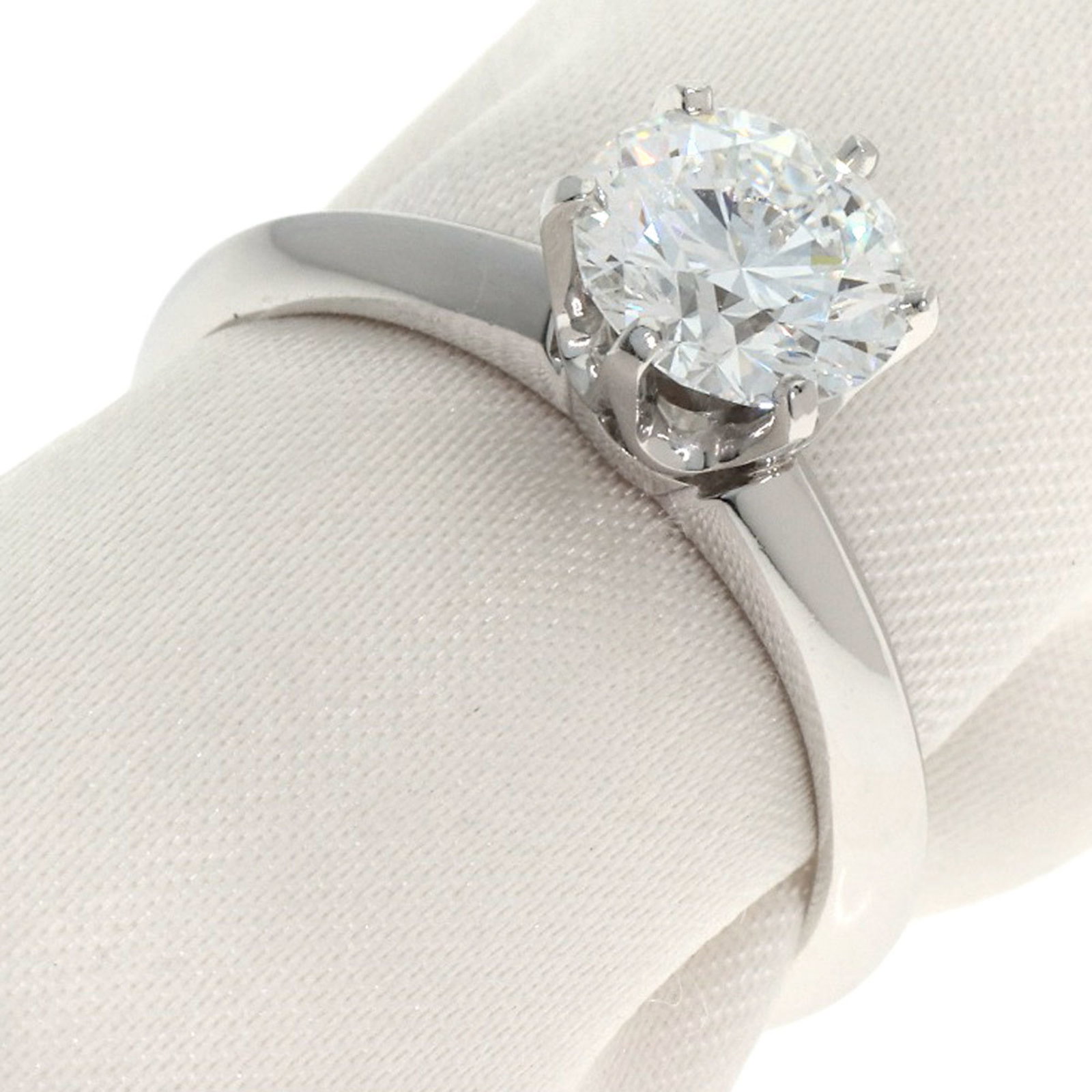 Platinum ring by Tiffany band: Platinum ring by Tiffany band Platinum ring by Tiffany features a diamond stone set in a band ring. The item has some scratches and dirt, but overall remains in very good condition with only a few