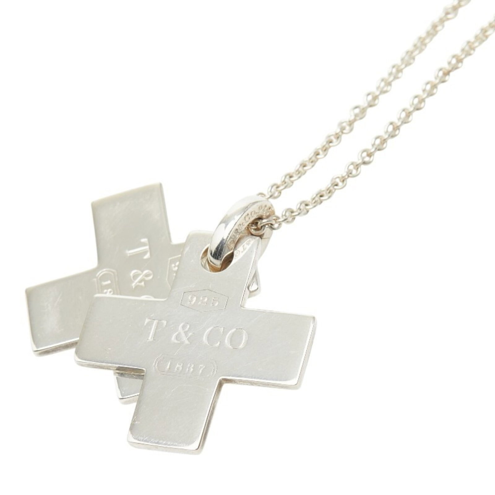 Women's double cross pendant in silver Sv925 by Tiffany & Co.: Women's double cross pendant in silver Sv925 by Tiffany & Co. Silver Sv925 double cross pendant in silver by Tiffany & Co. features a striking design, with intricate details and a classic style that e