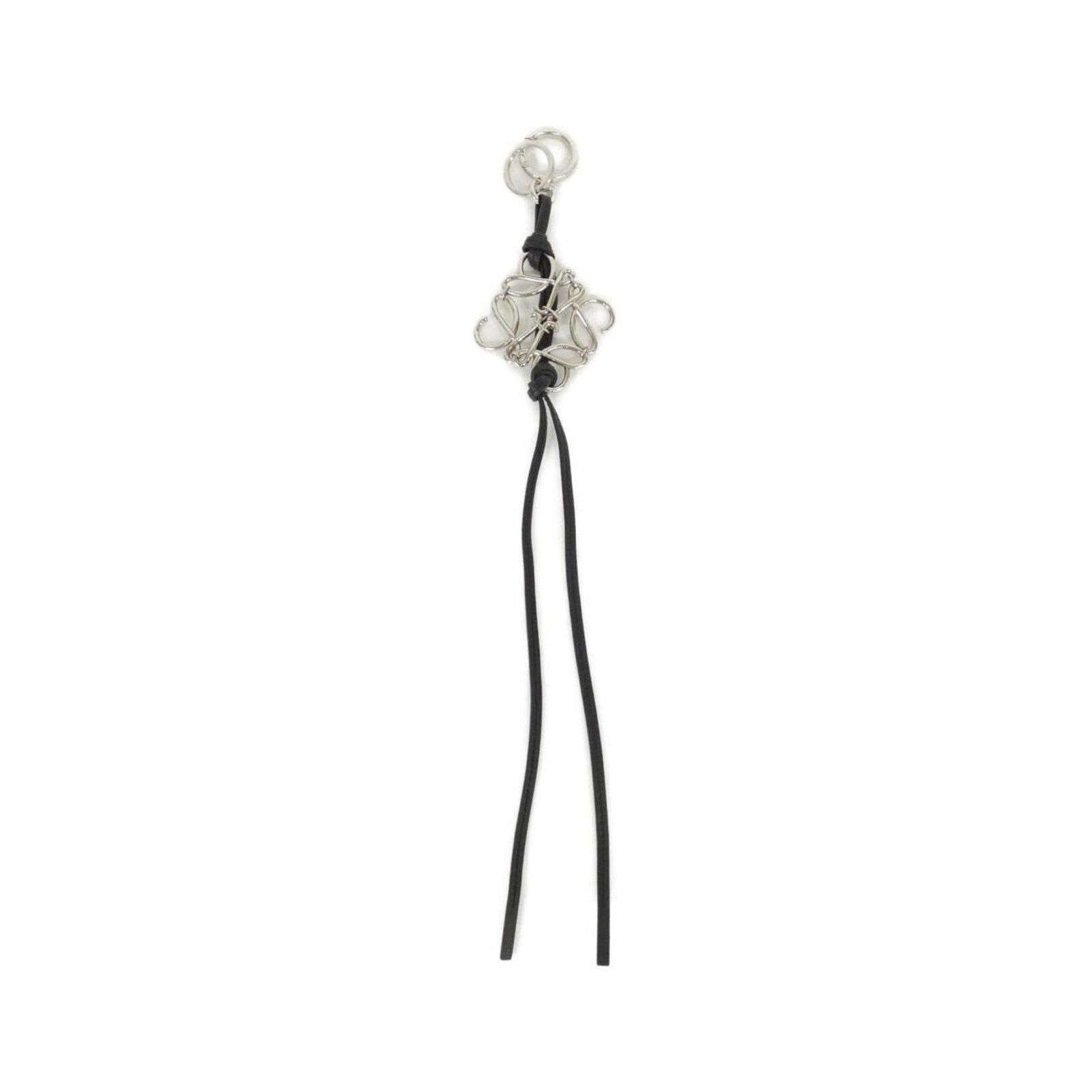 Loewe Handbag Charm Leather: Loewe Handbag Charm Leather This black Loewe Handbag Charm Leather features high-quality calfskin material and bears a signature. The charm has some scratches and dirt, but remains in very good