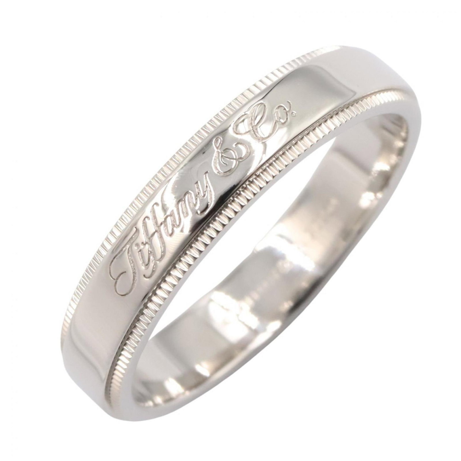 Platinum ring by Tiffany band: Platinum ring by Tiffany band Platinum ring by Tiffany features a silver band with a subtle shine, crafted from high-quality platinum. The item shows some minor signs of wear, including faint