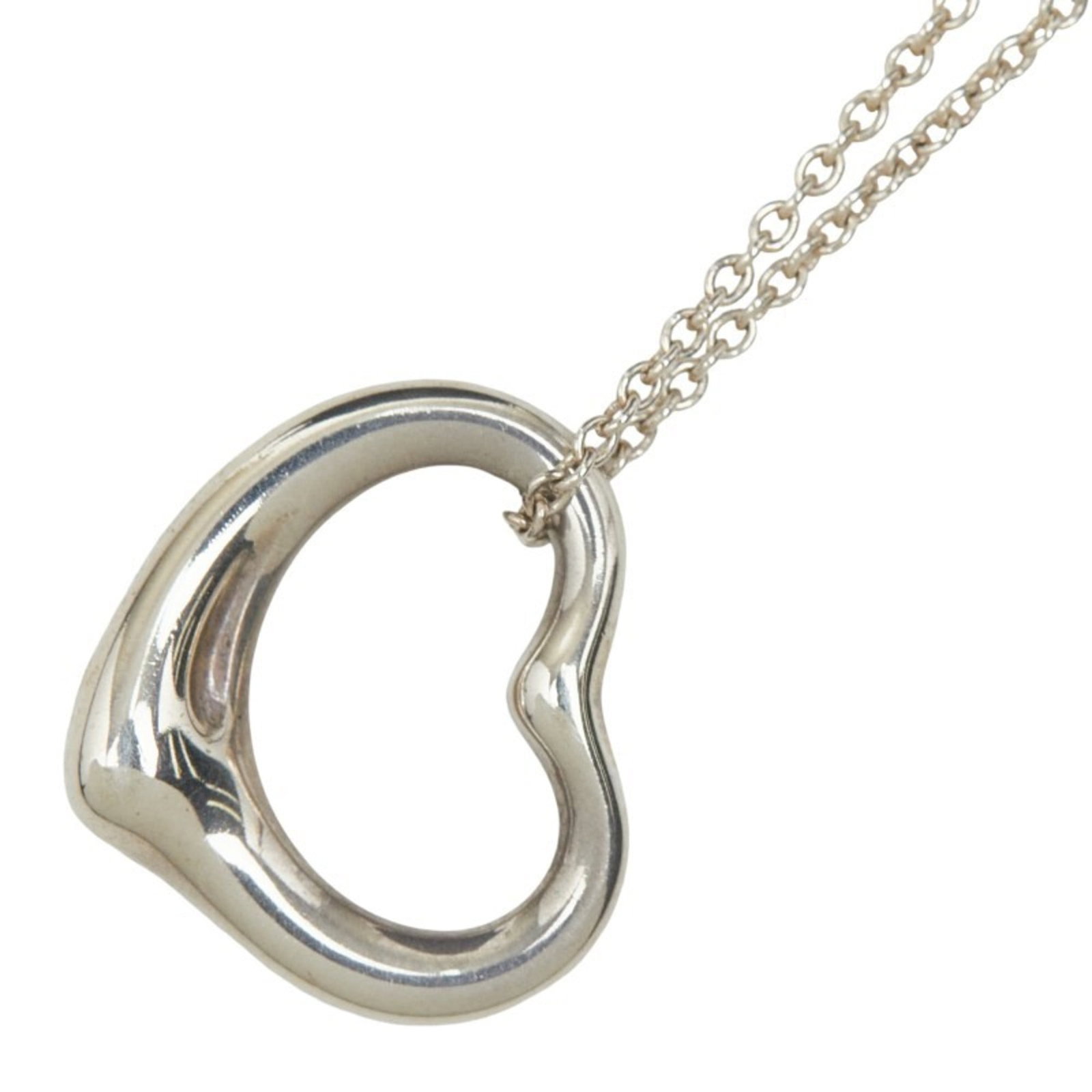 Sterling silver open heart necklace for women by Tiffany and Co: Sterling silver open heart necklace for women by Tiffany and Co Sterling silver open heart necklace by Tiffany and Co, featuring a classic design with intricate details. The necklace boasts a timeless