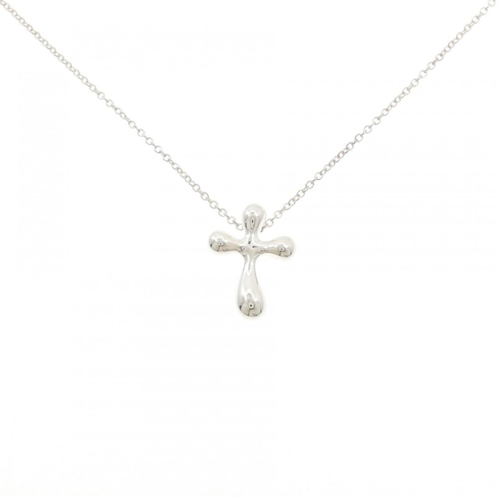 Cross Necklace by Tiffany: Cross Necklace by Tiffany Silver 925 cross necklace by Tiffany, featuring a 15.8mm x 11.8mm pendant with a subtle scratch and some dirt, available in a 41 cm / 16.14'' circumference chain. This used n