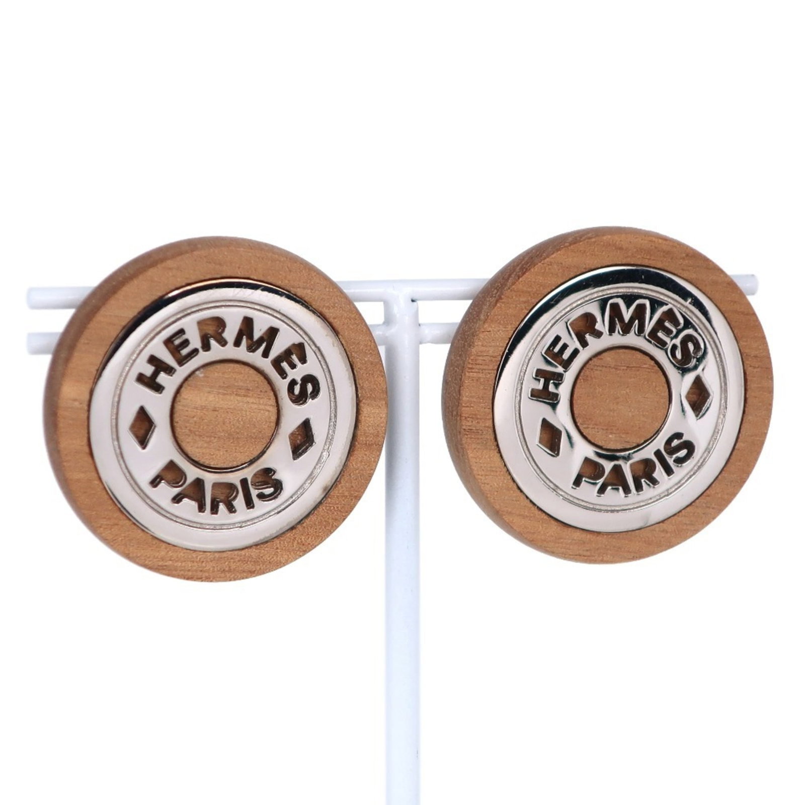 Hermes Serie Earrings Wood X Metal Brown/ Silver Women'S: Hermes Serie Earrings Wood X Metal Brown/ Silver Women'S Brown and silver-toned wood earrings with metal accents, characteristic of the Hermes Serie E design. The wooden elements exhibit natural wear,