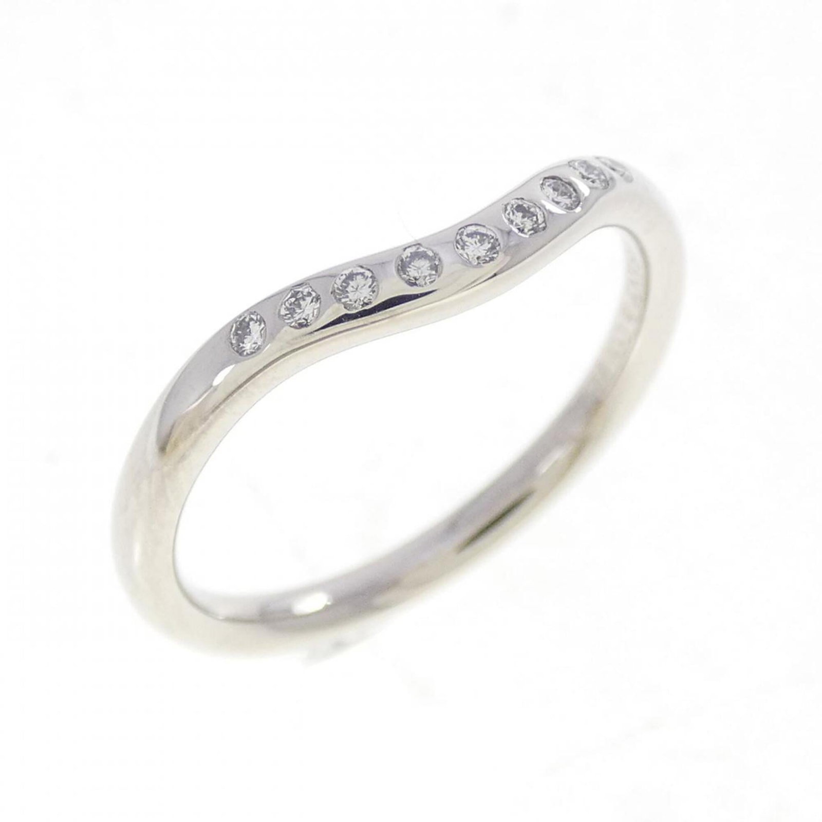 Platinum ring by Tiffany band: Platinum ring by Tiffany band Platinum ring by Tiffany features a diamond stone set in a band design. The item is made from platinum and has a us size of 4, with some minor scratches and dirt visible 